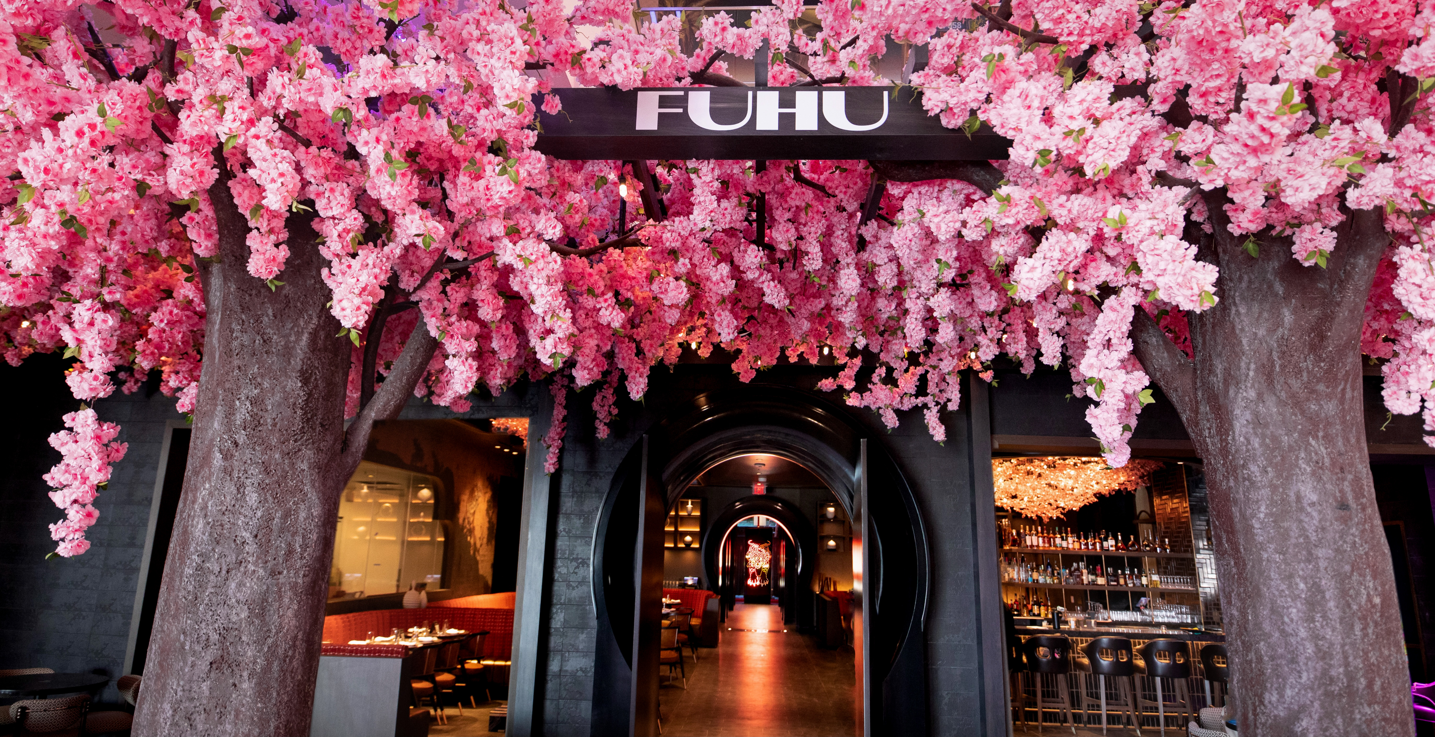 The exterior of a restaurant with pink flowers