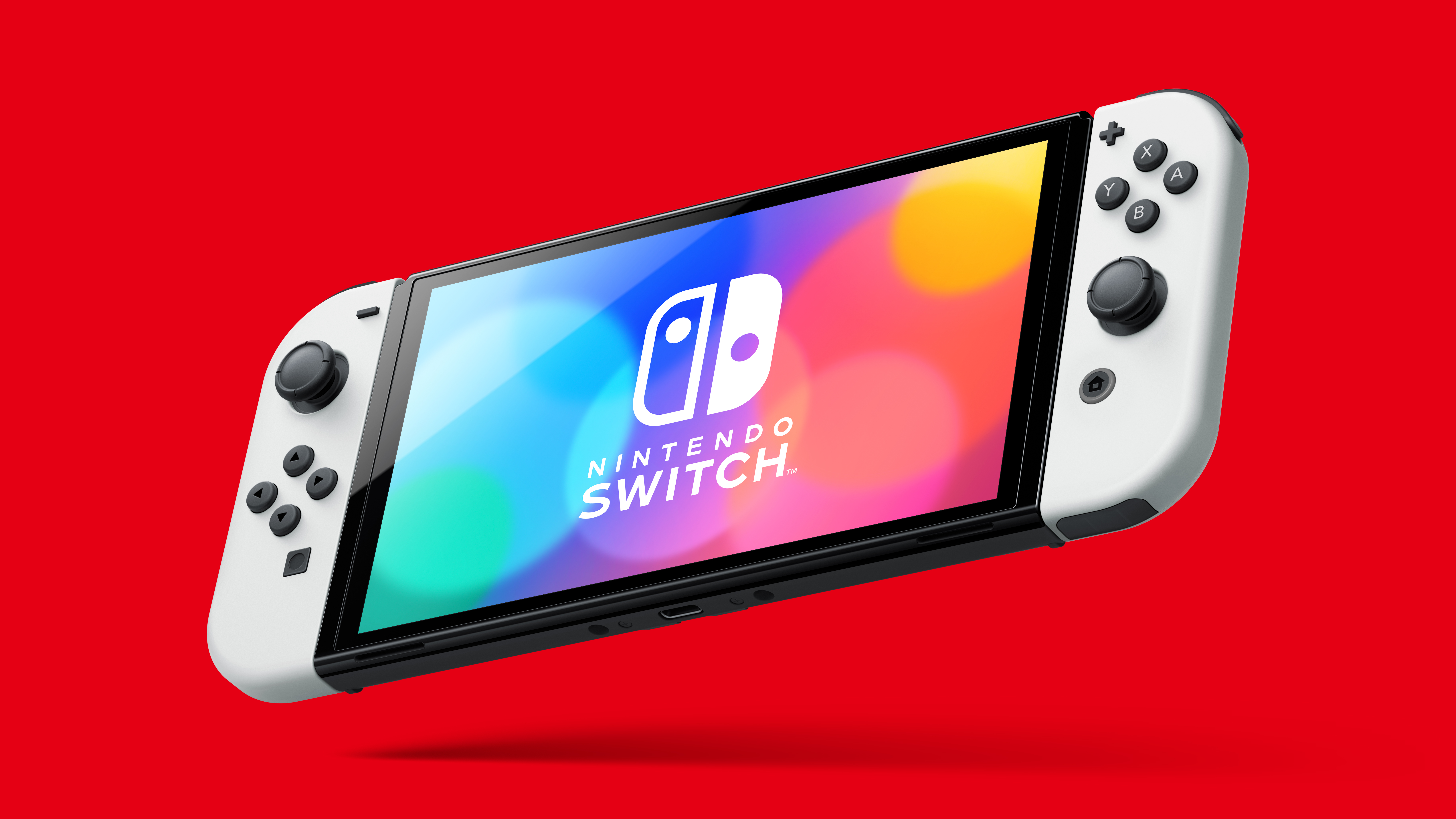 The new Nintendo Switch (OLED model) in handheld mode on a red background