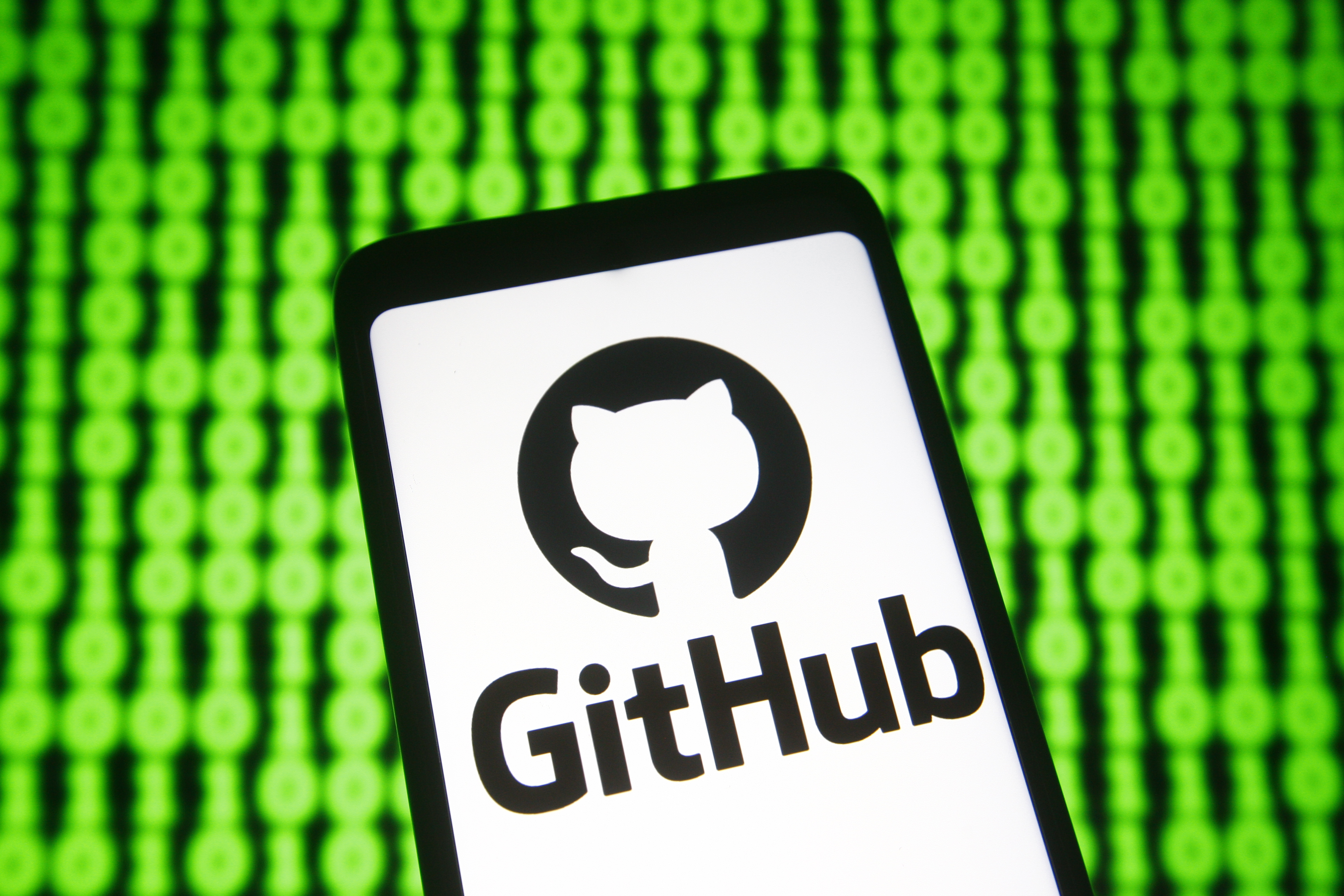 In this photo illustration a GitHub logo of a provider of...