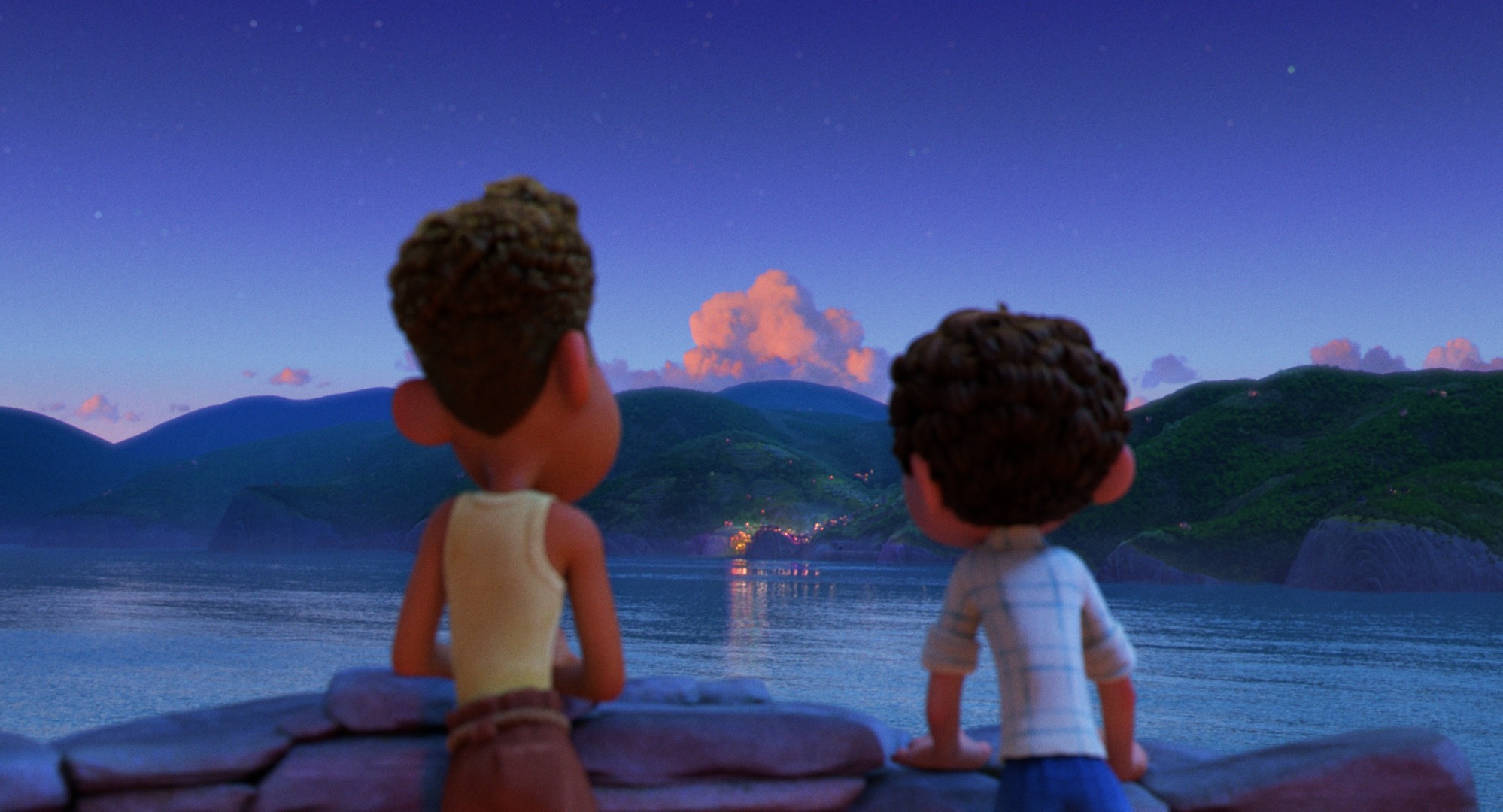 luca and alberto looking out at a town in the evening