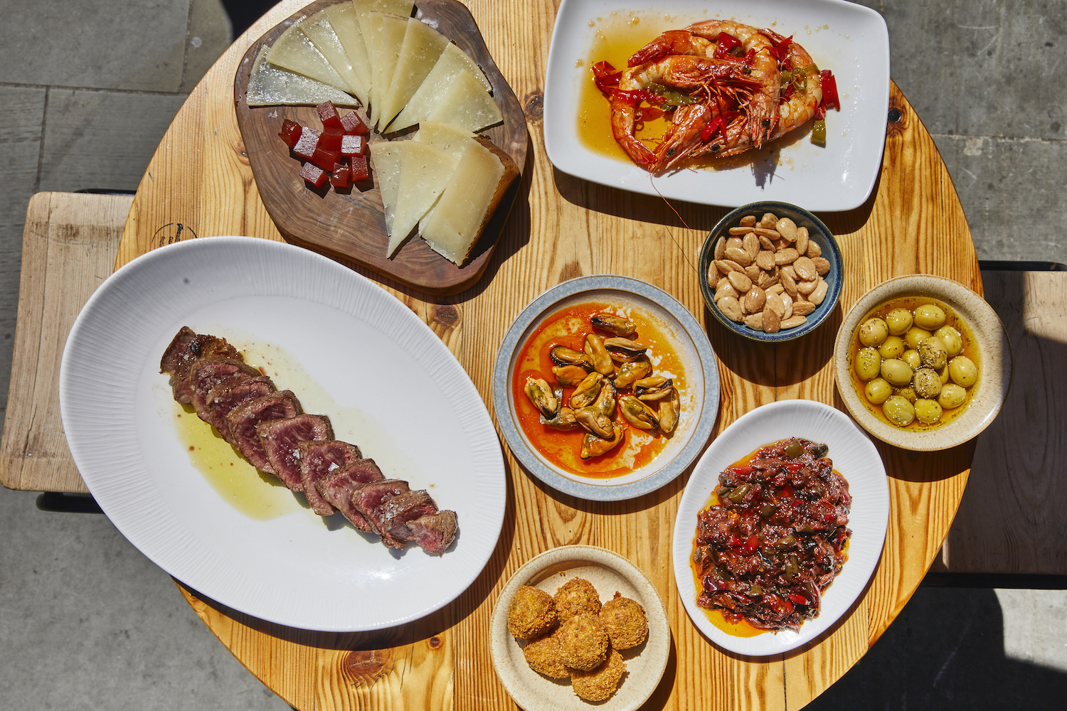 A table of José Pizarro’s Spanish classics, including Ibérico presa with flaky salt; red prawns in chilli and garlic; croquetas; olives; cheese; and escalivada
