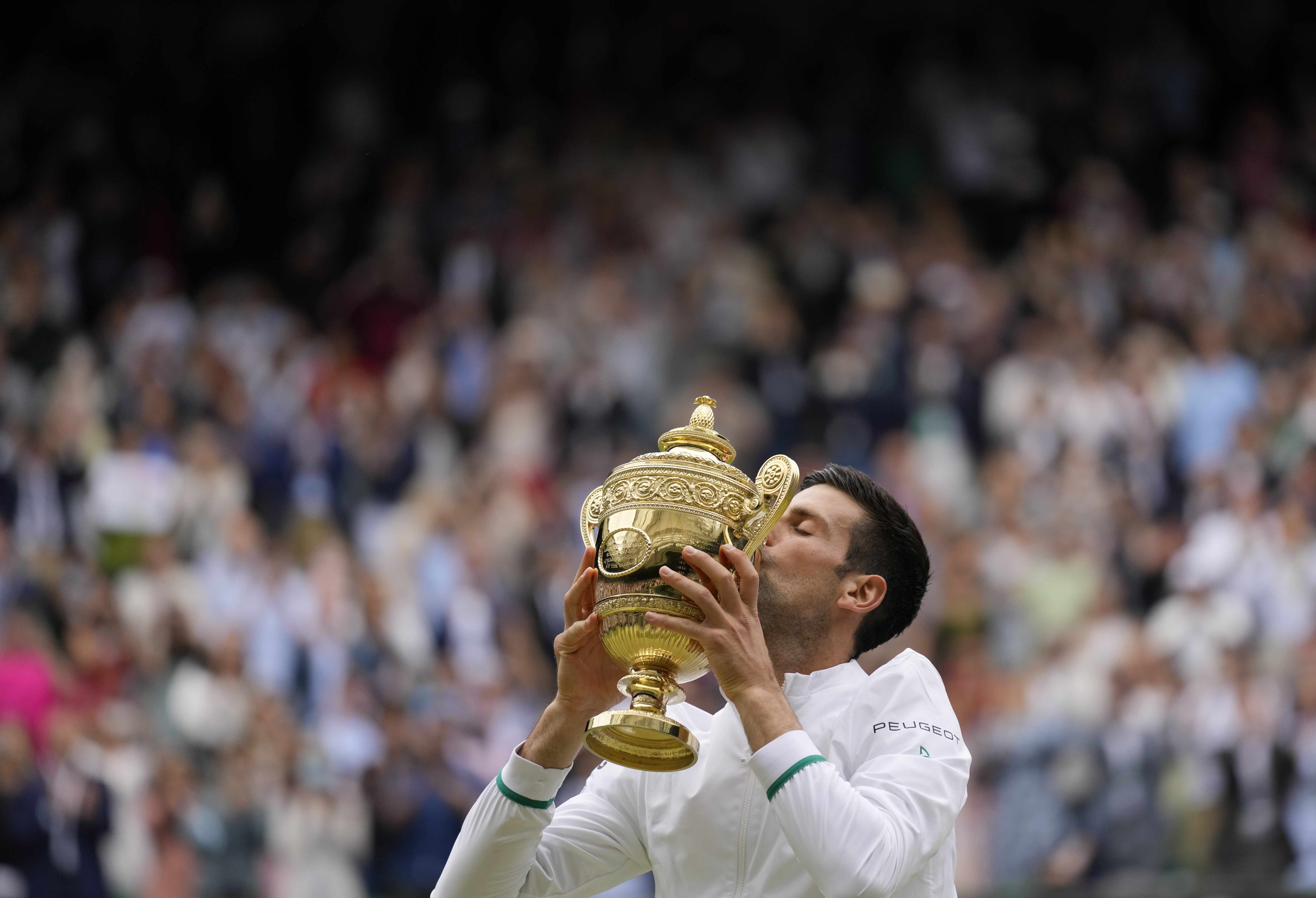 Novak Djokovic kisses the trophy after winning Wimbledon. 