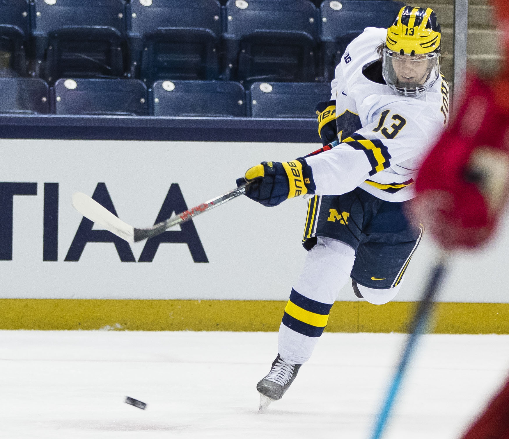 Michigan’s Kent Johnson (13) shoots during the Michigan vs. Ohio State Big Ten Hockey Tournament game Sunday, March 14, 2021 at the Compton Family Ice Arena in South Bend.
