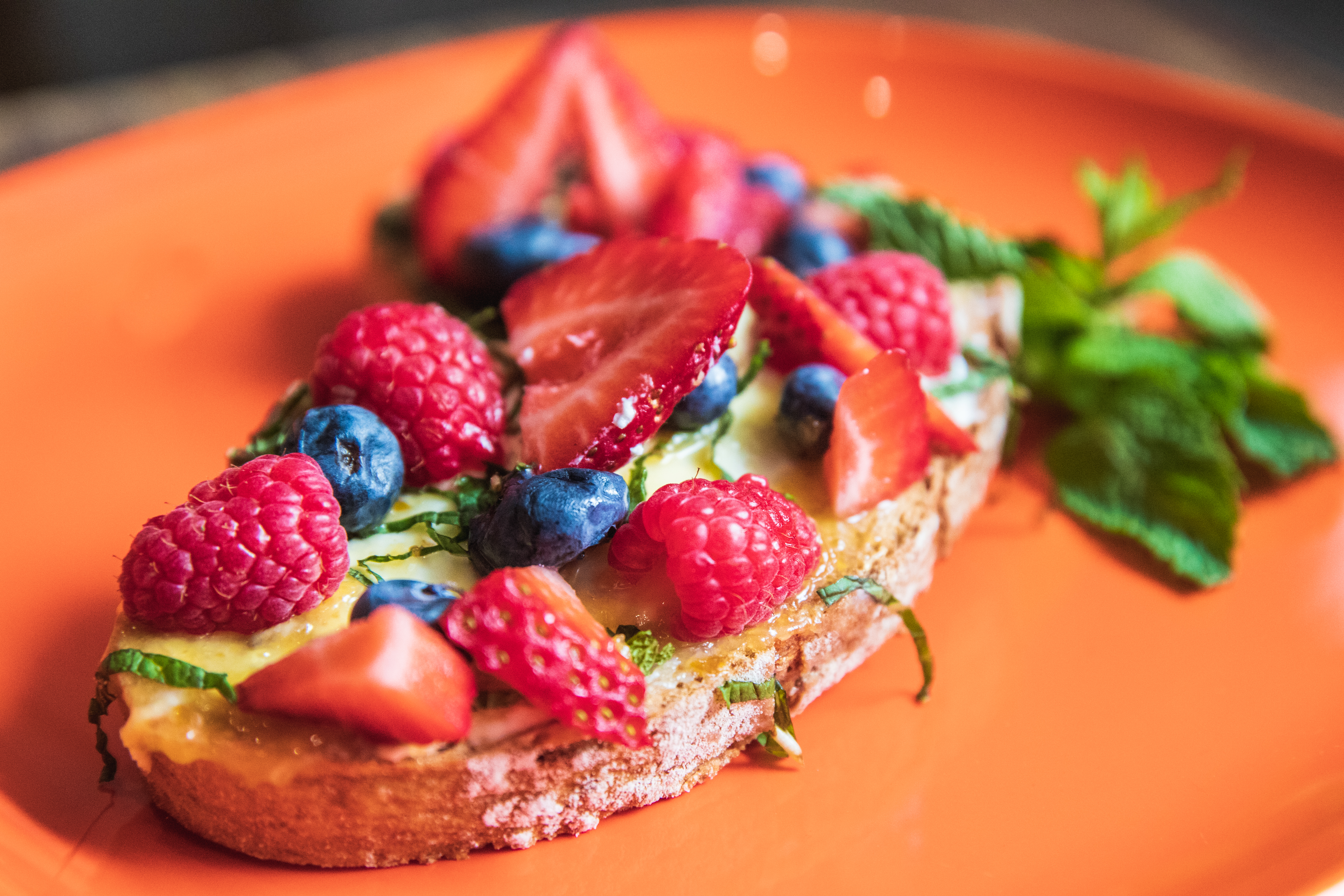 A scrumptious piece of toast loaded up with fruit.,