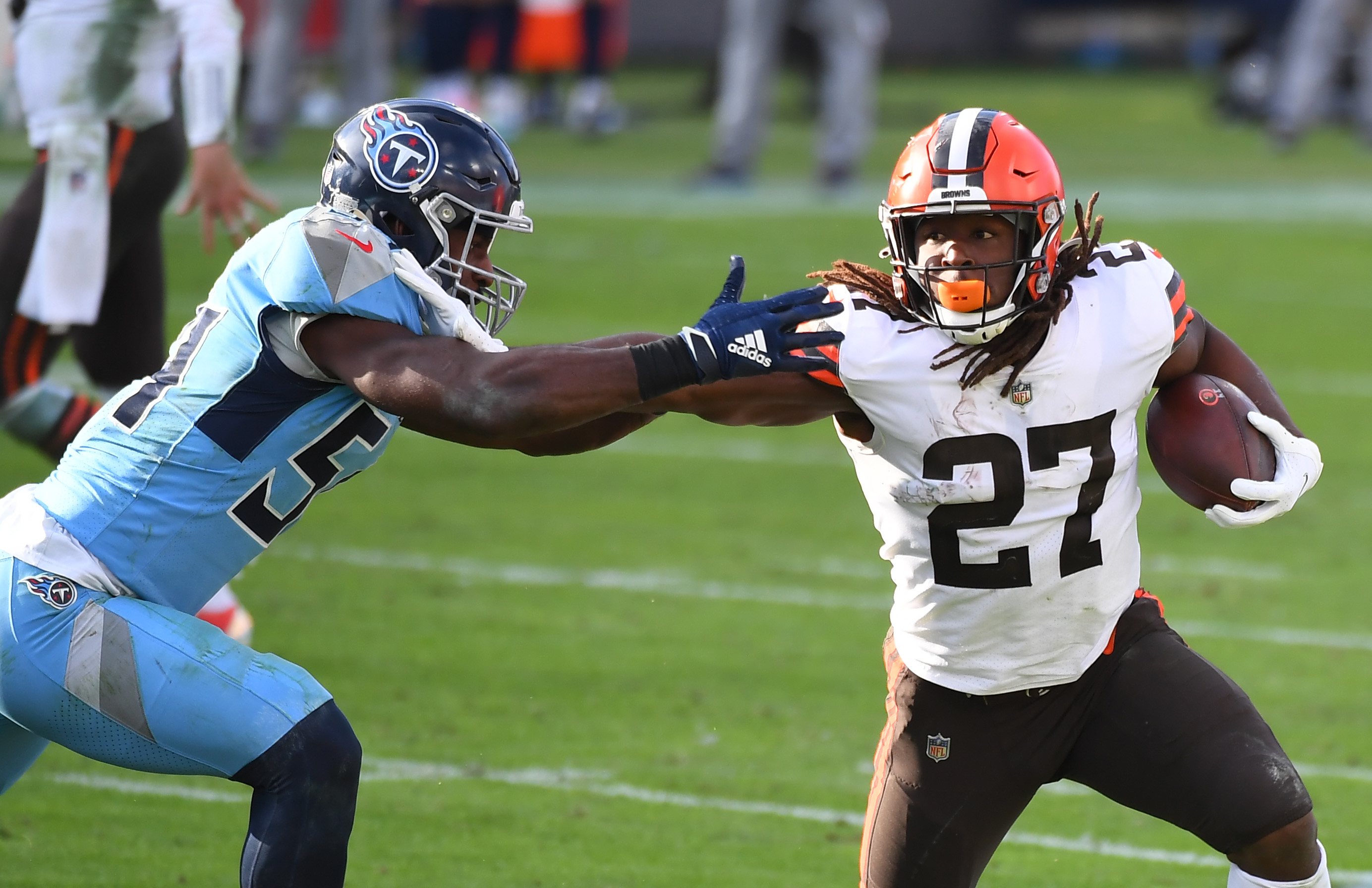 Cleveland Browns running back Kareem Hunt (27) fights off a tackle attempt from Tennessee Titans inside linebacker Rashaan Evans (54) during the second half at Nissan Stadium.