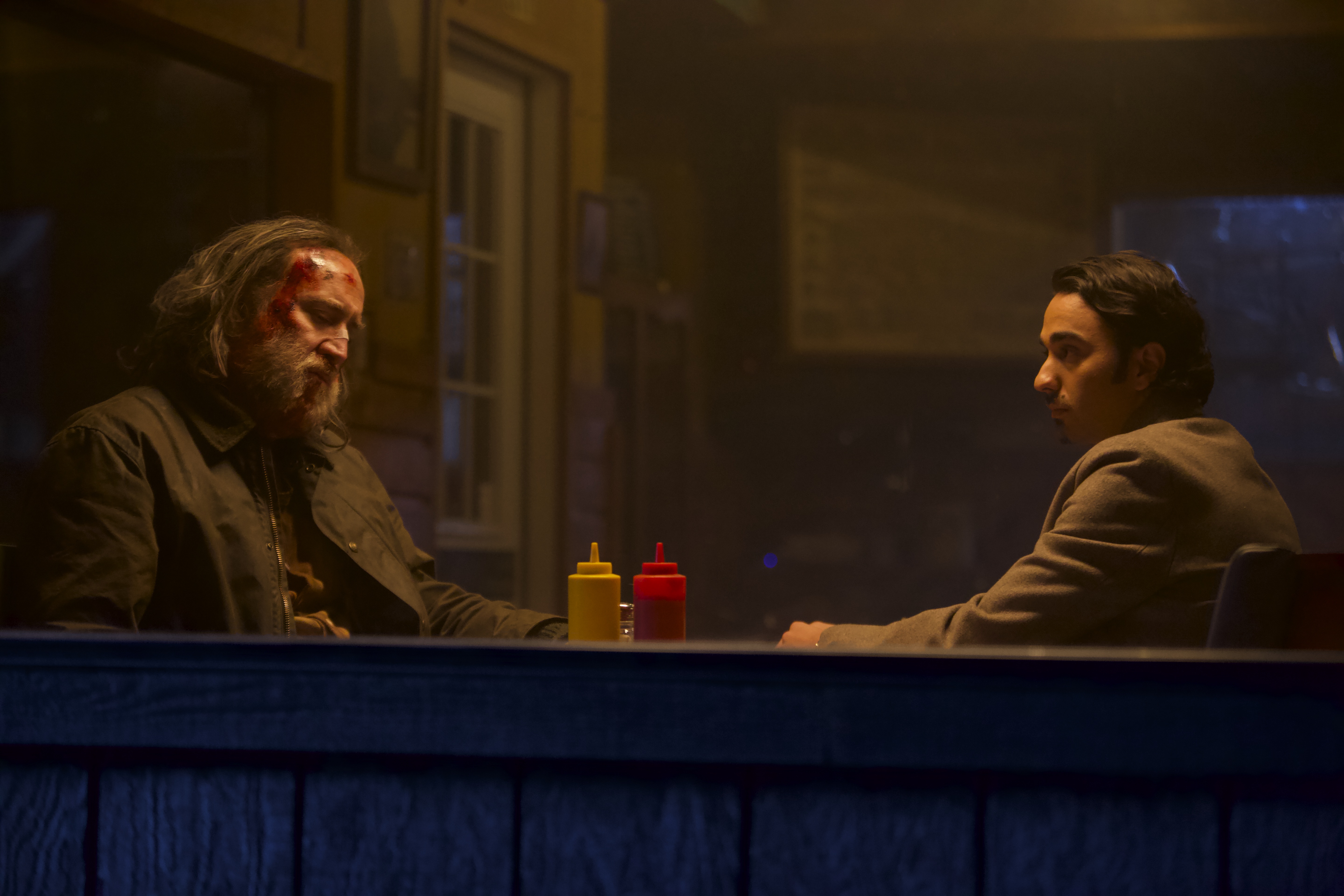 A still from ‘Pig’ featuring Nicolas Cage and Alex Wolff sitting in a diner.