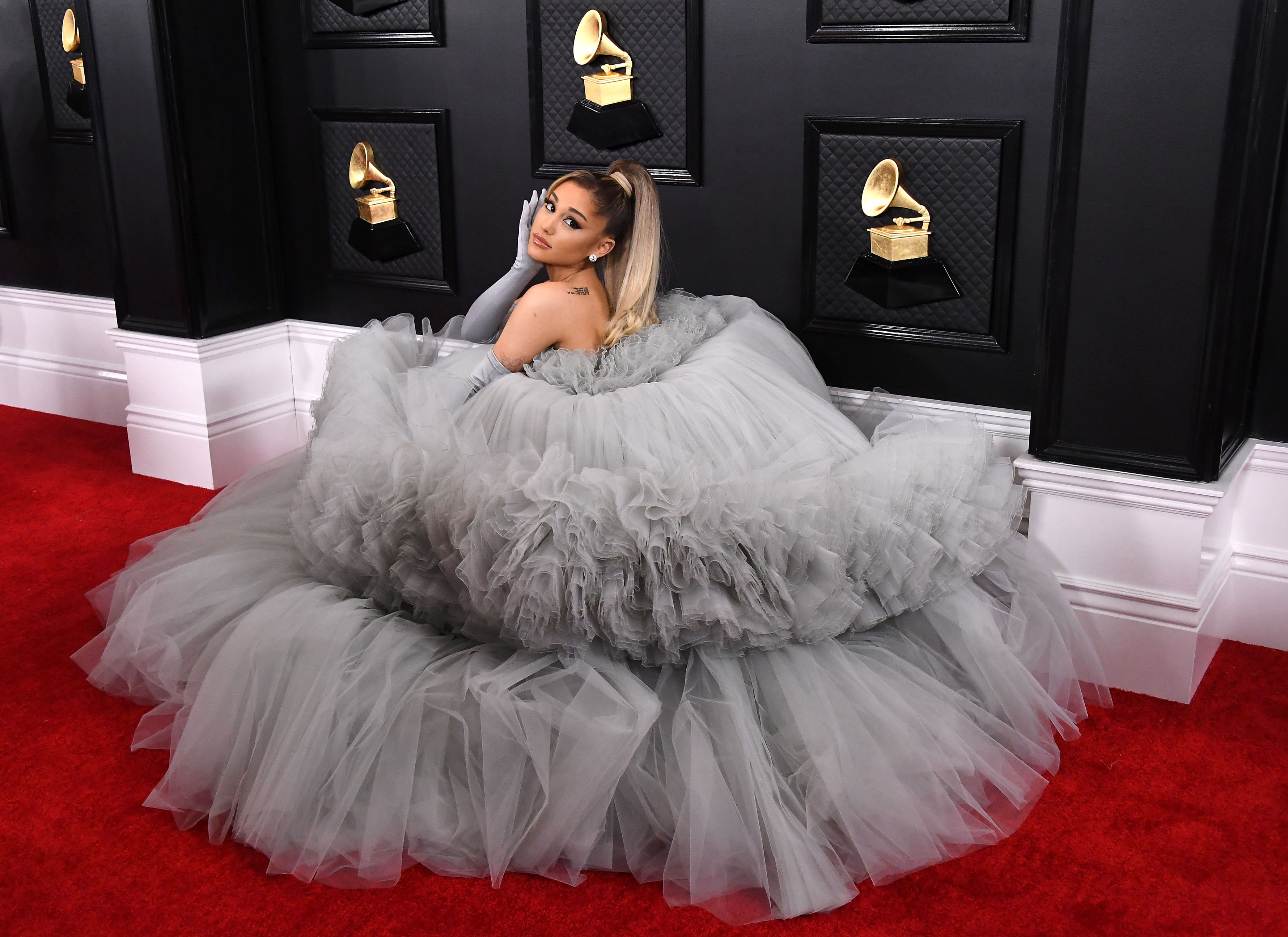Ariana Grande in a dress with a very large skirt of pleated tulle.