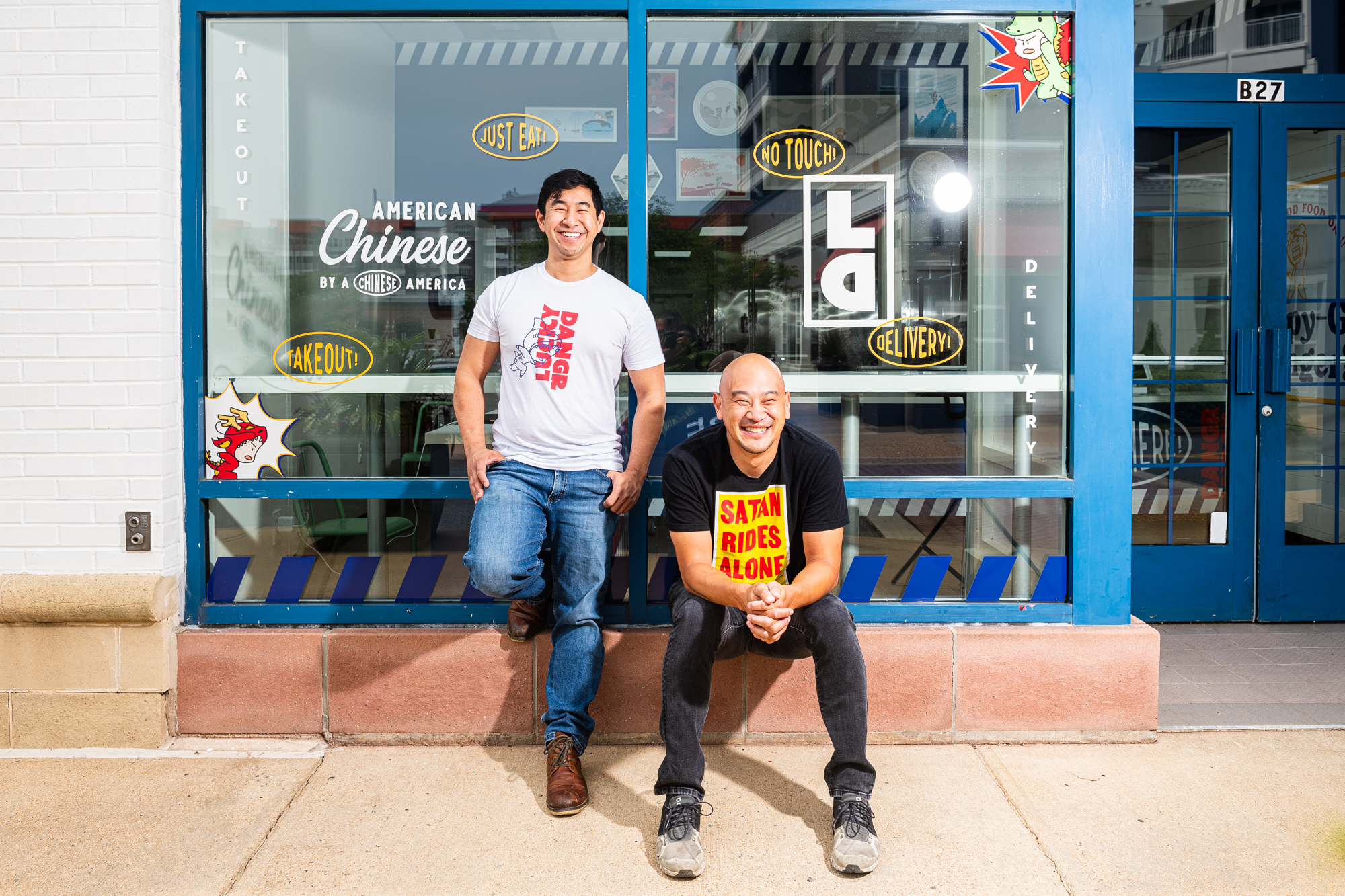 Lucky Danger founders Tim Ma, right, and Andrew Chiou pose in front of their new takeout storefront in Arlington, Virginia