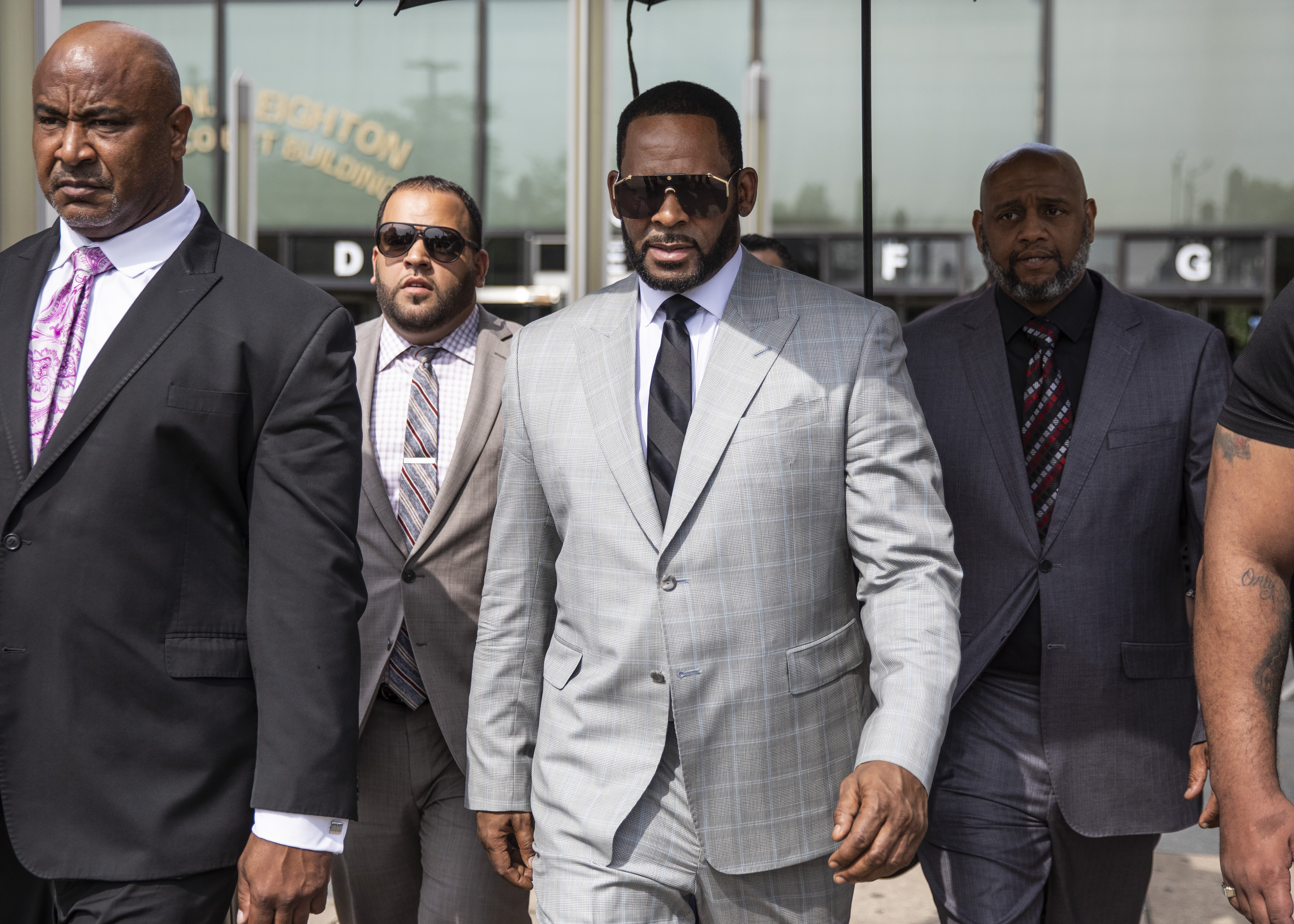 R. Kelly walks with supporters out of the Leighton Criminal Courthouse in June 2019.