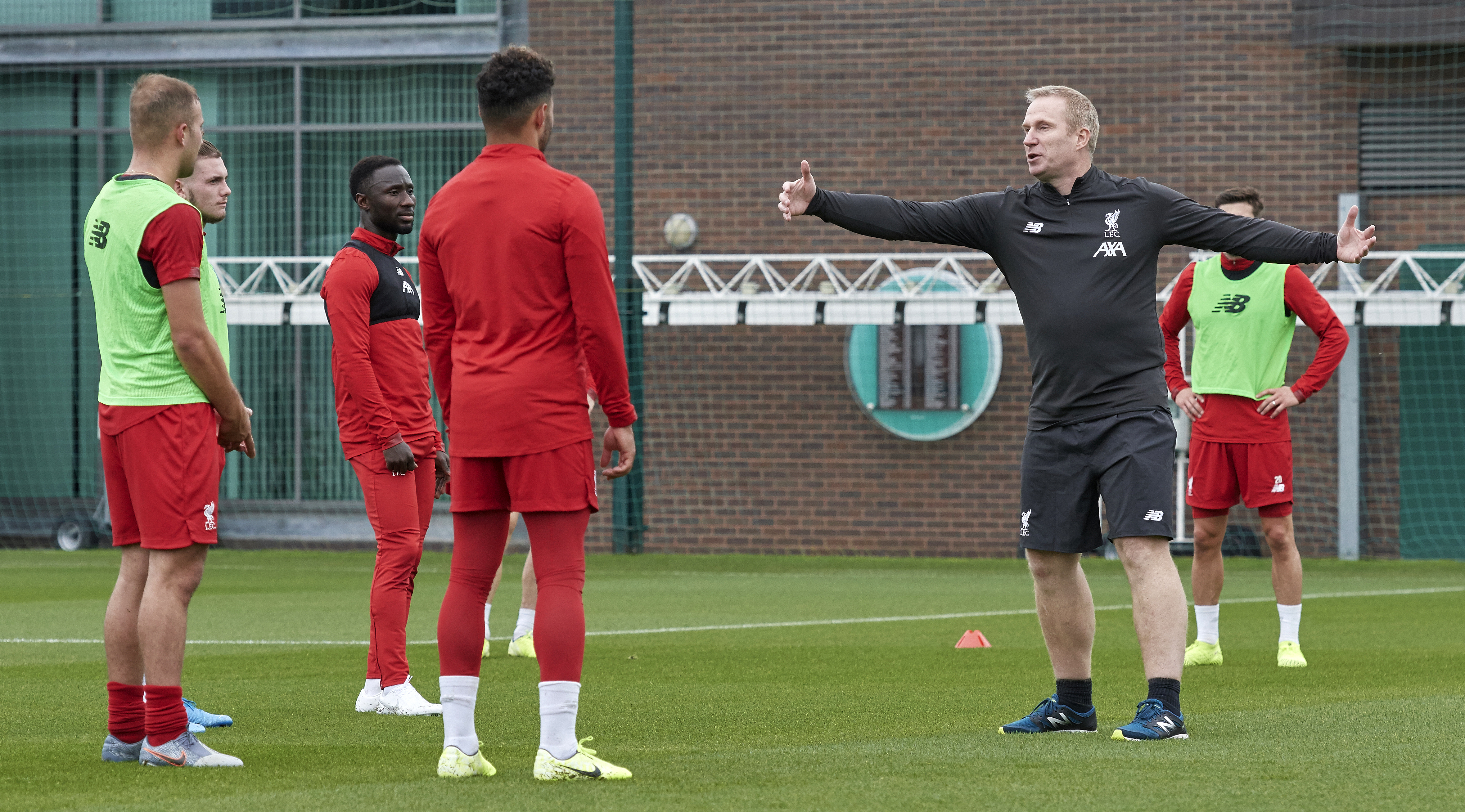 Coach Thomas Gronnemark speaks to the players of Liverpool during a training session at Melwood Training Ground on October 15, 2019 in Liverpool, England.