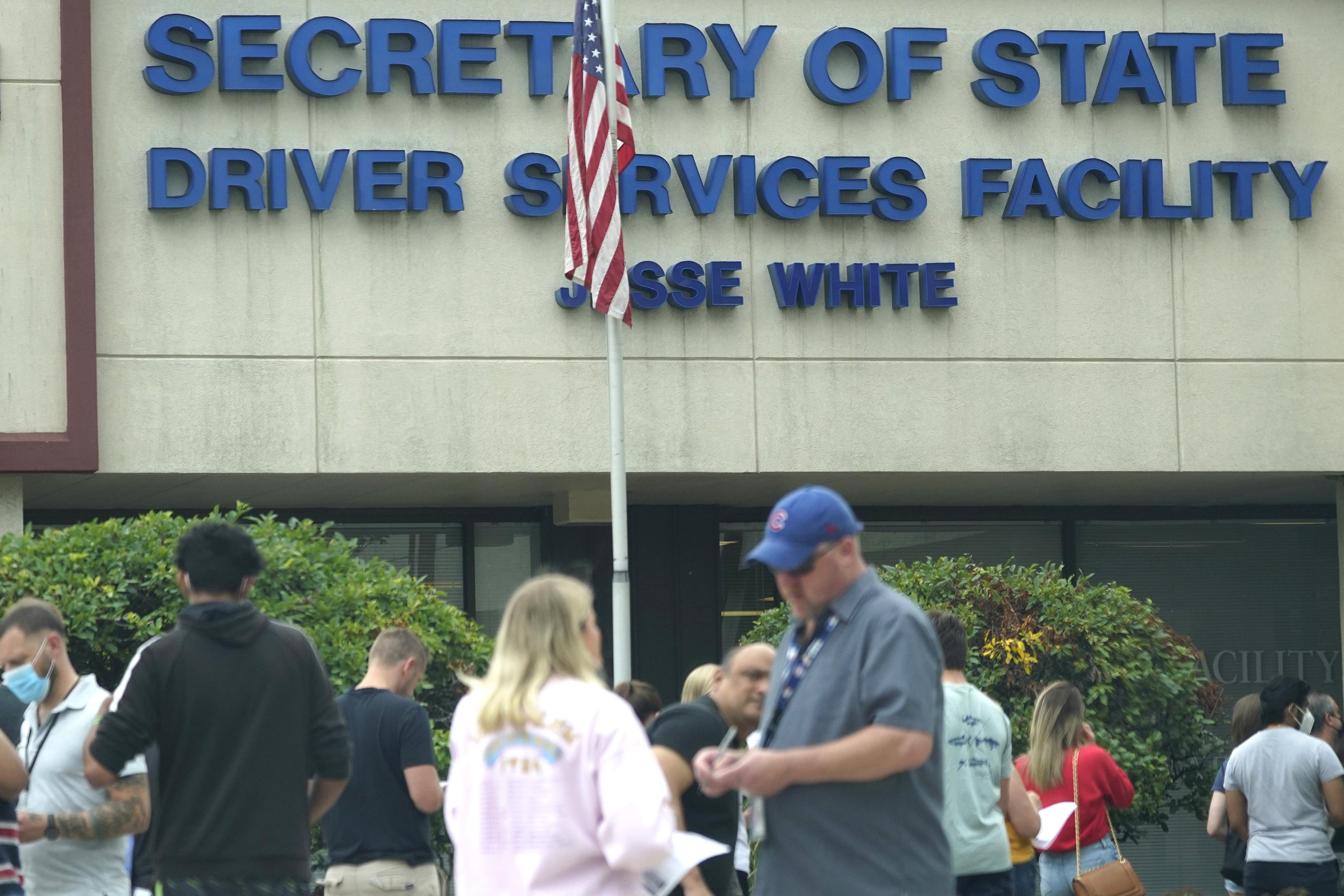 People line up to enter the Illinois Driver Services Center in Schaumburg, Ill., Thursday, July 15, 2021. 