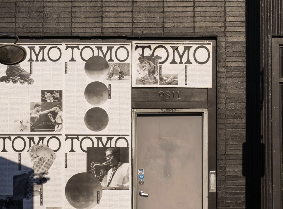 The exterior of Tomo in White Center, with the restaurant’s name plastered on the wall as black-and-white vintage posters