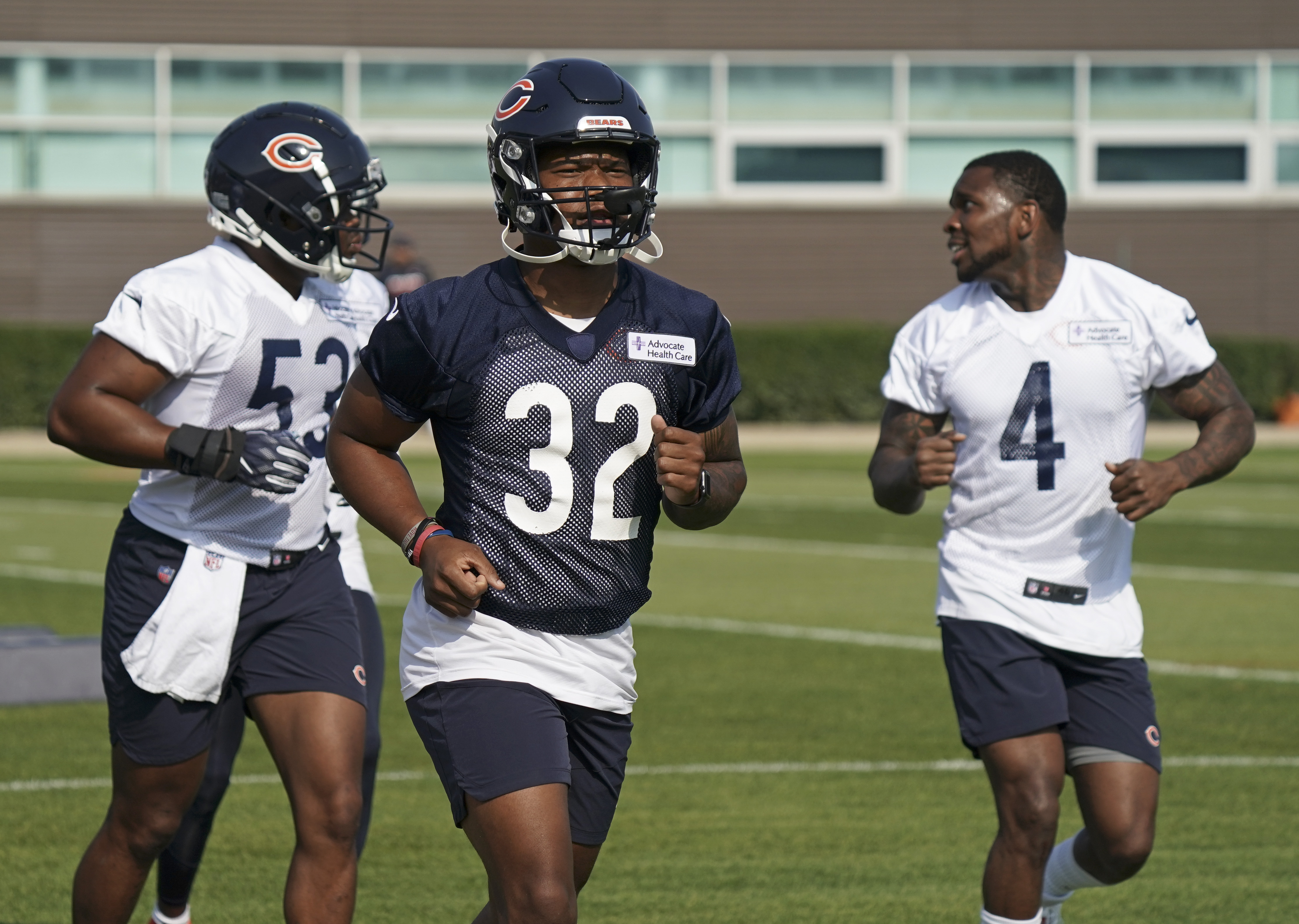 Ledarius Mack #53, David Montgomery #32, and Eddie Jackson #4 of the Chicago Bears run on the field during training camp at Halas Hall on July 29, 2021 in Lake Forest, Illinois.