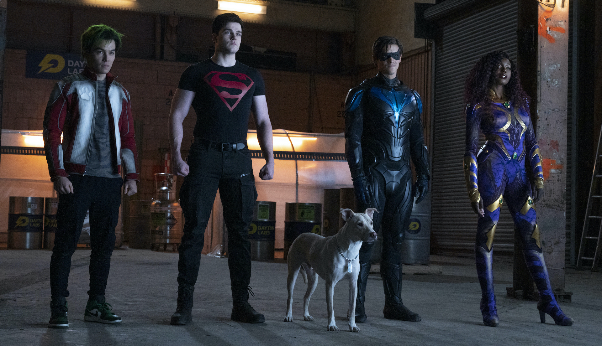 Ryan Potter, Joshua Orpin, Brenton Thwaites, Anna Diop stand in superhero-group lineup pose as Gar Logan, Superboy, Robin, and Starfire