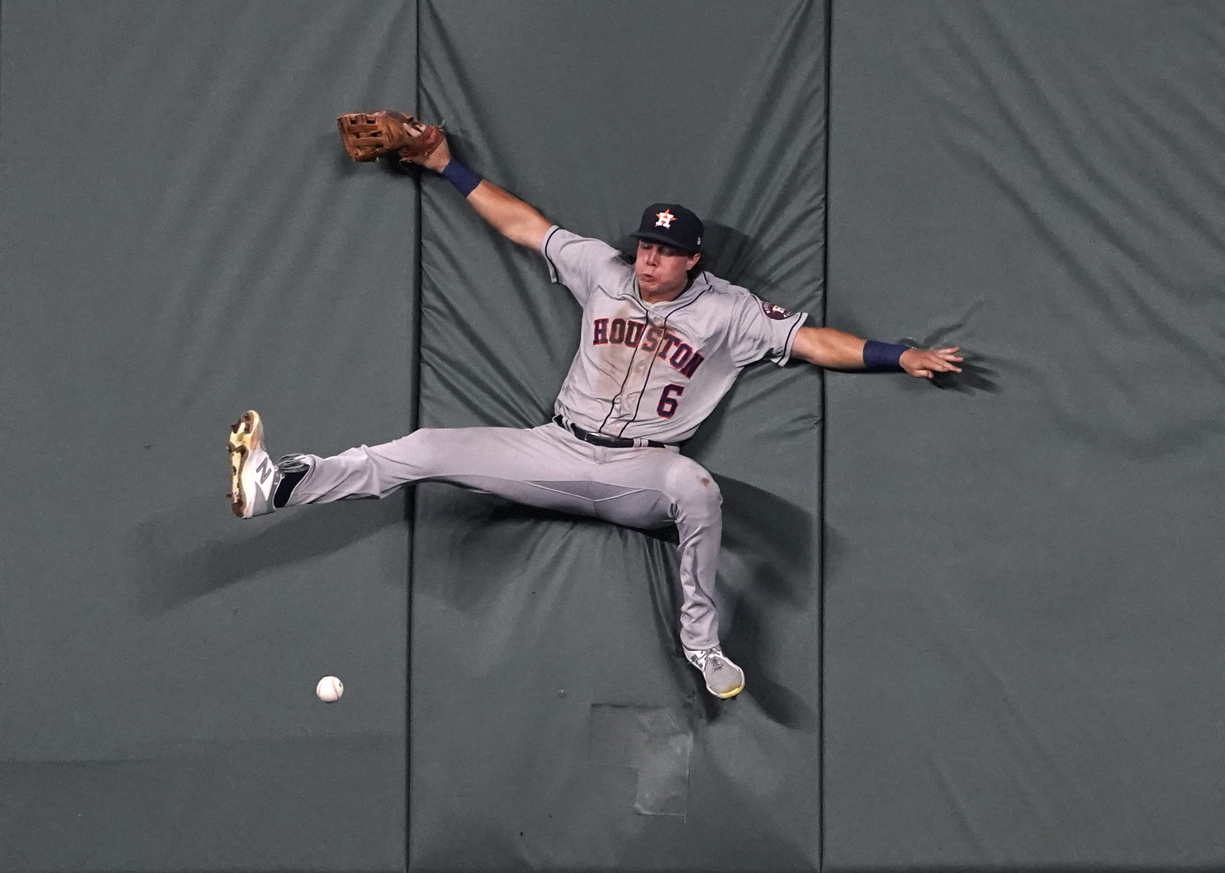 Jake Meyers #6 of the Houston Astros collides with the wall as he attempts to catch a ball hit by Carlos Santana of the Kansas City Royals in the fifth inning at Kauffman Stadium on August 16, 2021 in Kansas City, Missouri.