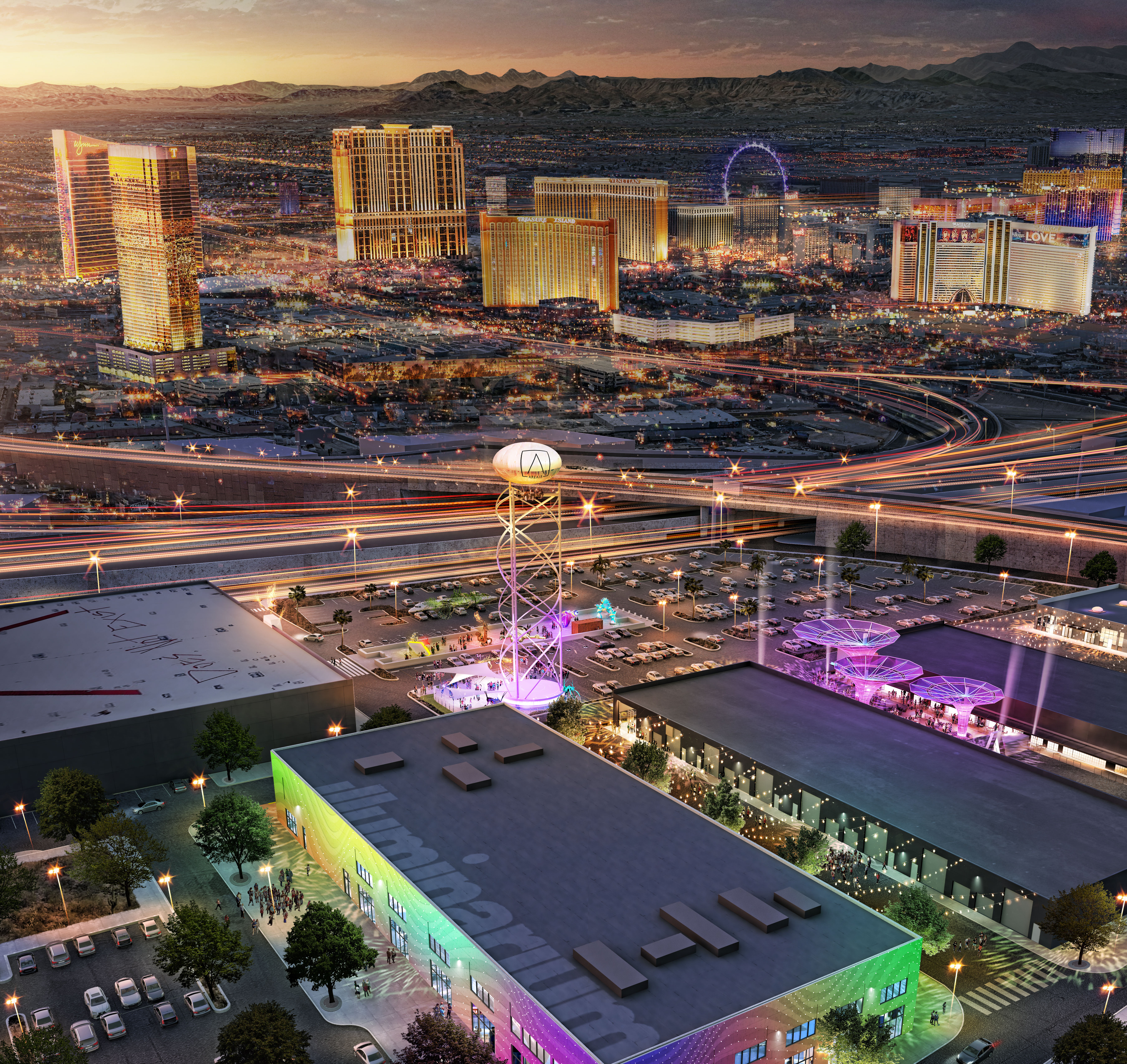 A view of an outdoor/indoor entertainment complex with the skyline of Las Vegas in the background