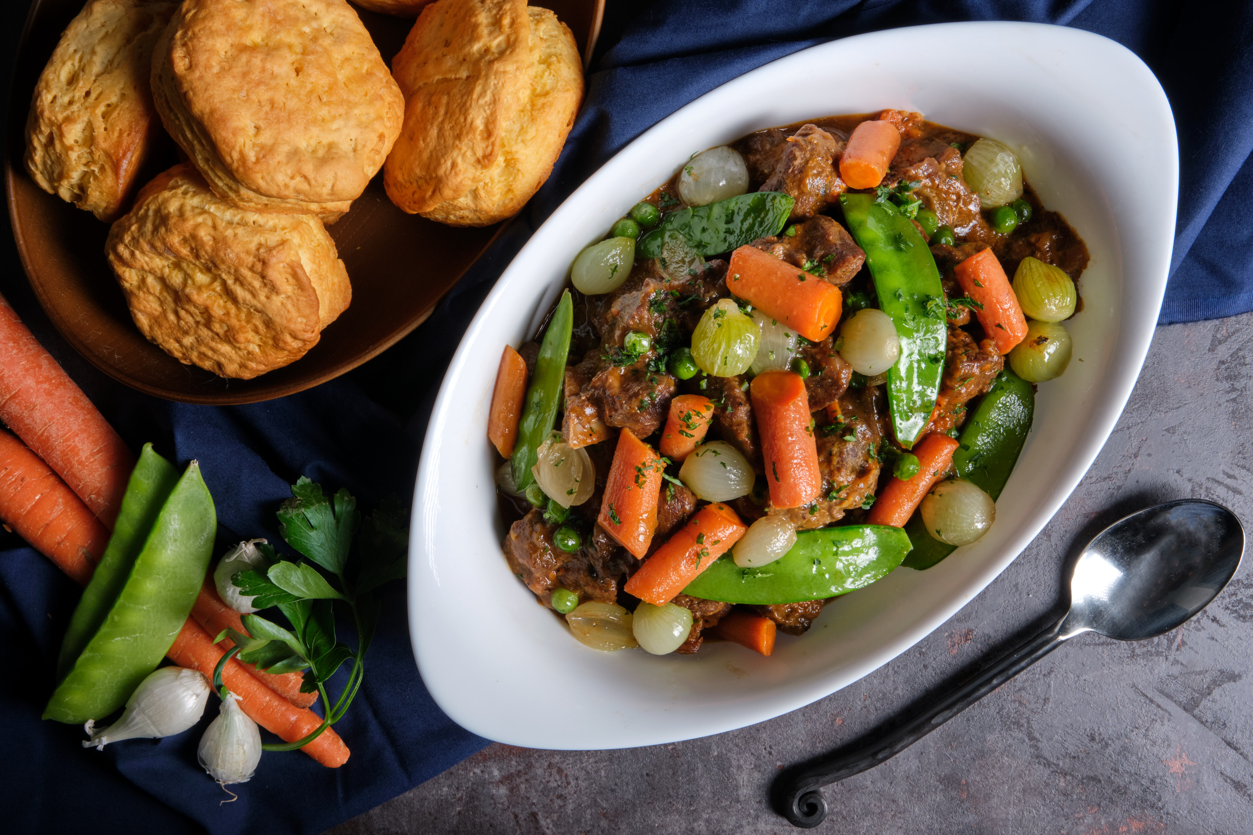 Lamb and vegetable stew in a white dutch oven