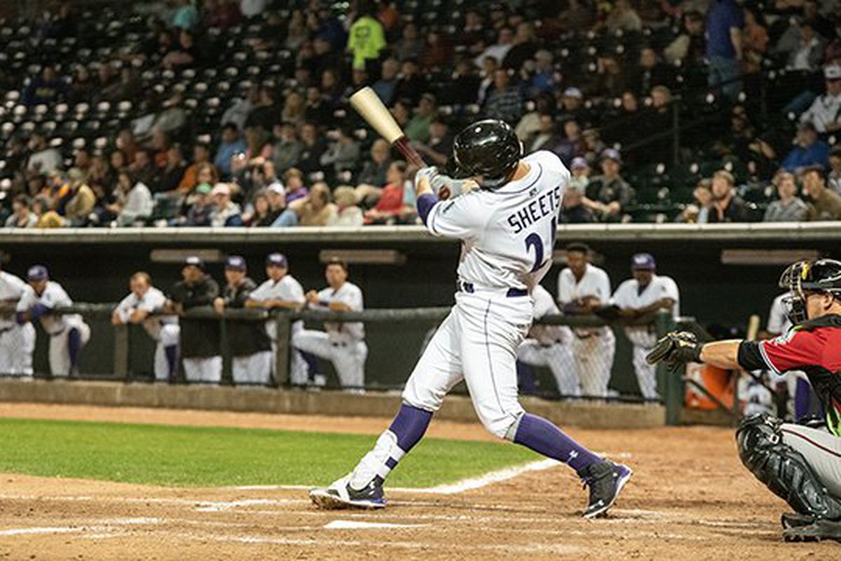 Gavin Sheets, in a Dash uniform, is in the followthrough of a big swing at the plate, viewed from his open side