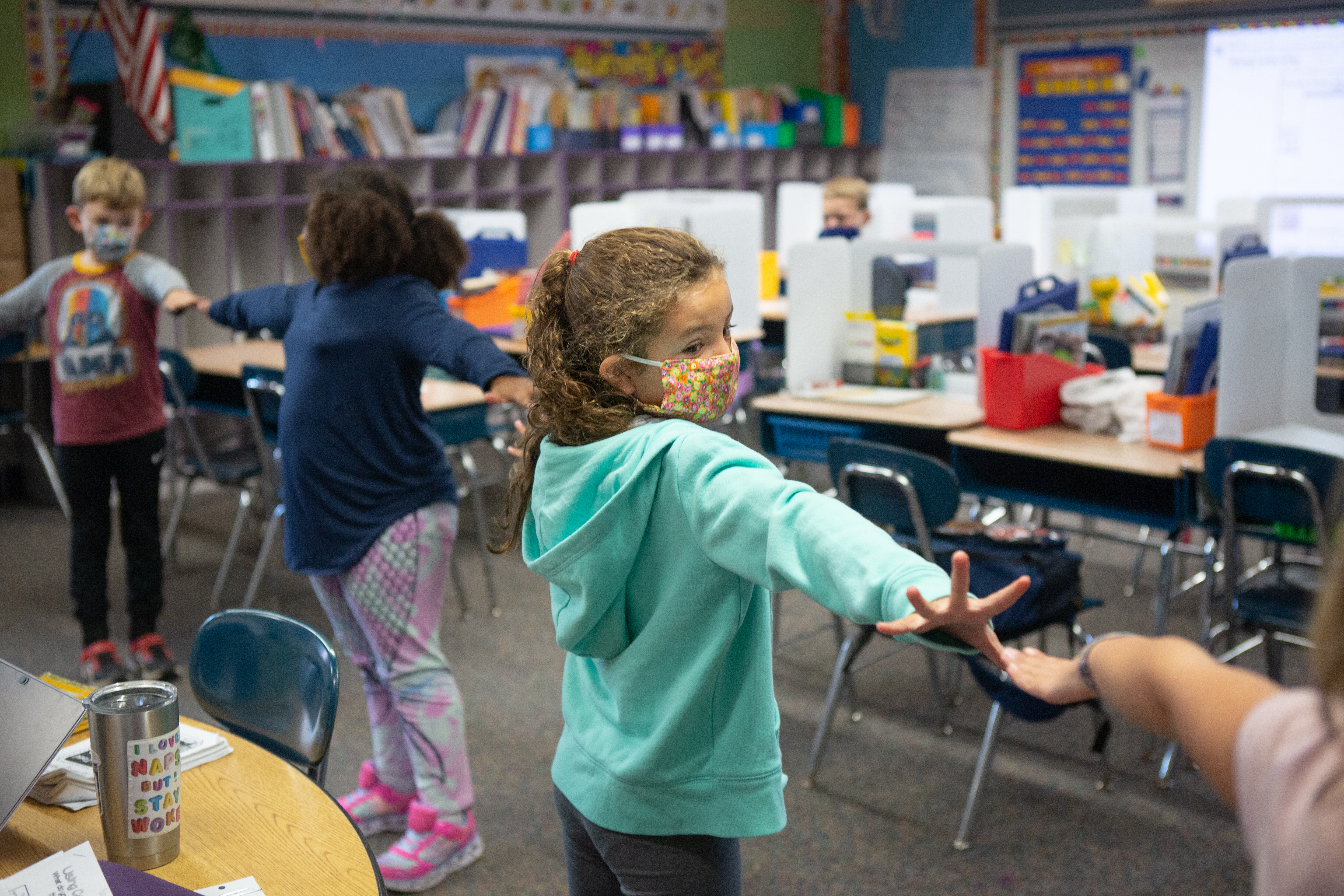 Students create distance between each other using their arms as they line up to go outside in Mrs. Cecarelliís second grade class at Wesley Elementary School in Middletown, CT, October 5, 2020.