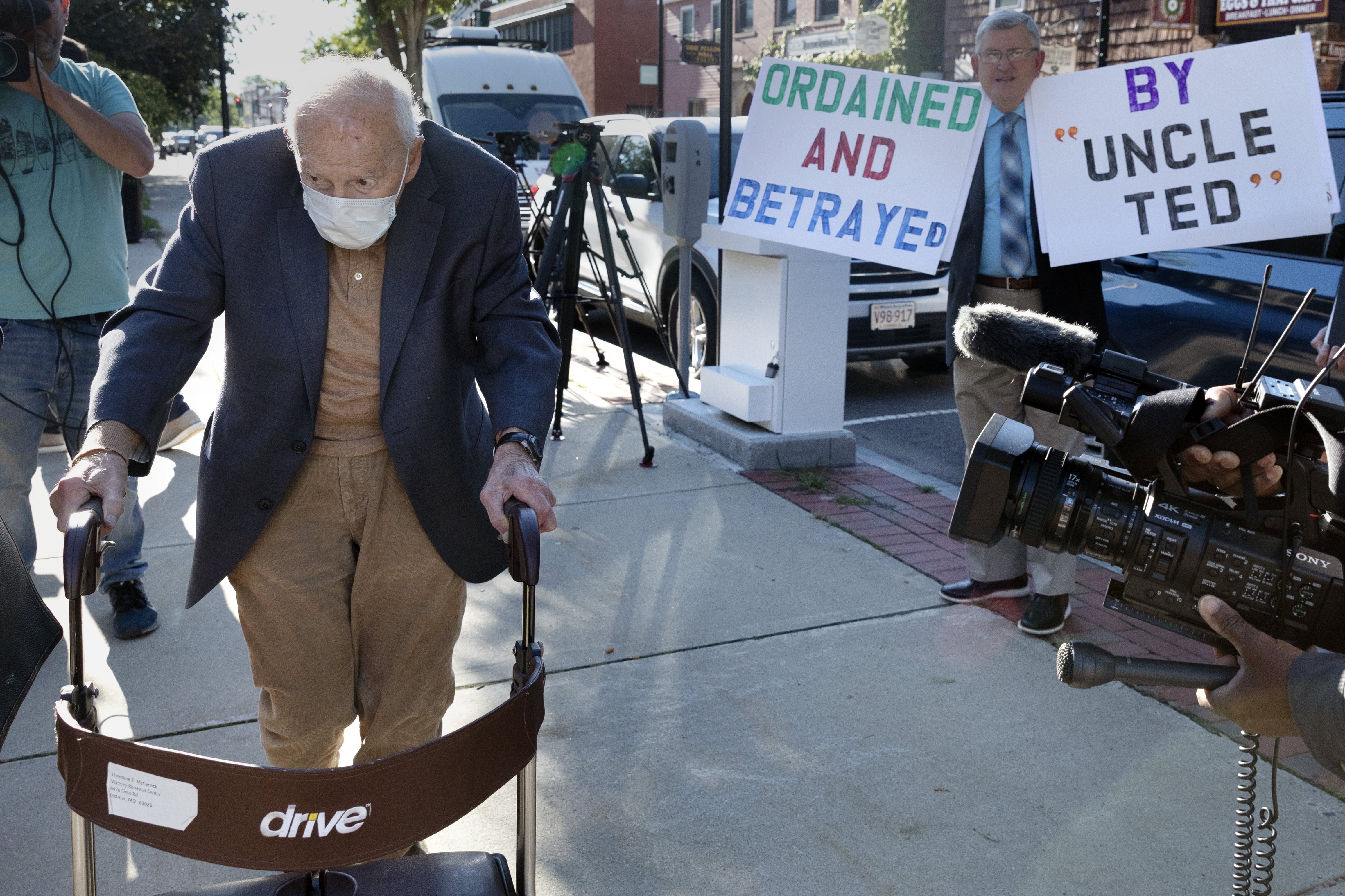 Defrocked Cardinal Theodore McCarrick, using a walker, arrives at court Friday in Dedham, Mass., outside Boston. The once-powerful American prelate pleaded not guilty to sexually assaulting a 16-year-old boy during a wedding reception in Massachusetts nearly 50 years ago.