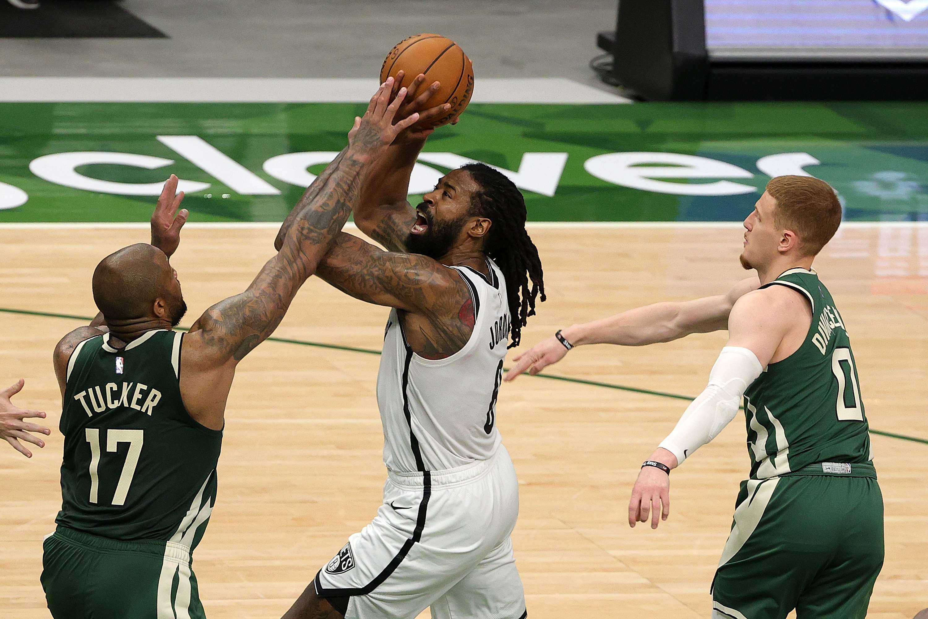 DeAndre Jordan of the Brooklyn Nets is defended by P.J. Tucker of the Milwaukee Bucks during the first half of a game at Fiserv Forum on May 02, 2021 in Milwaukee, Wisconsin.