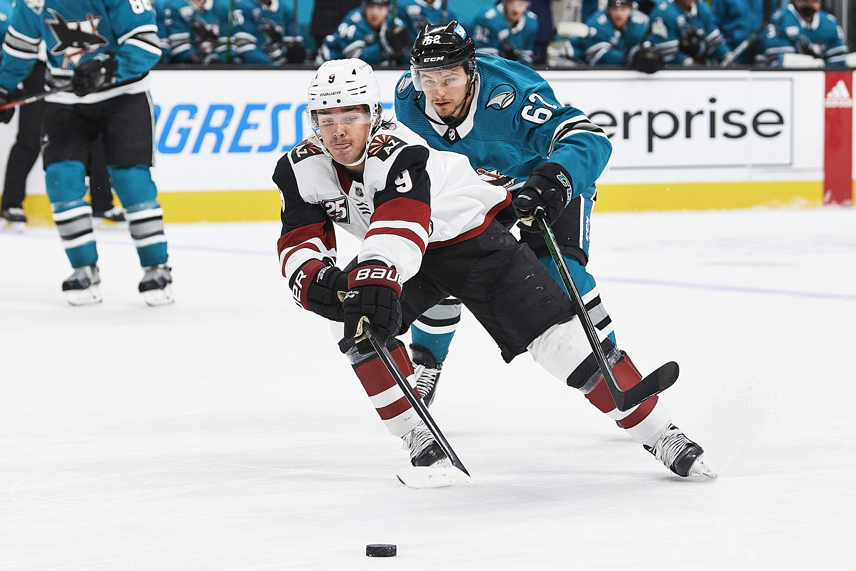 Arizona Coyotes right wing Clayton Keller (9) keeps the puck away from San Jose Sharks right wing Kevin Labanc (62) during the San Jose Sharks game versus the Arizona Coyotes on May 8, 2021, at SAP Center at San Jose in San Jose, CA.