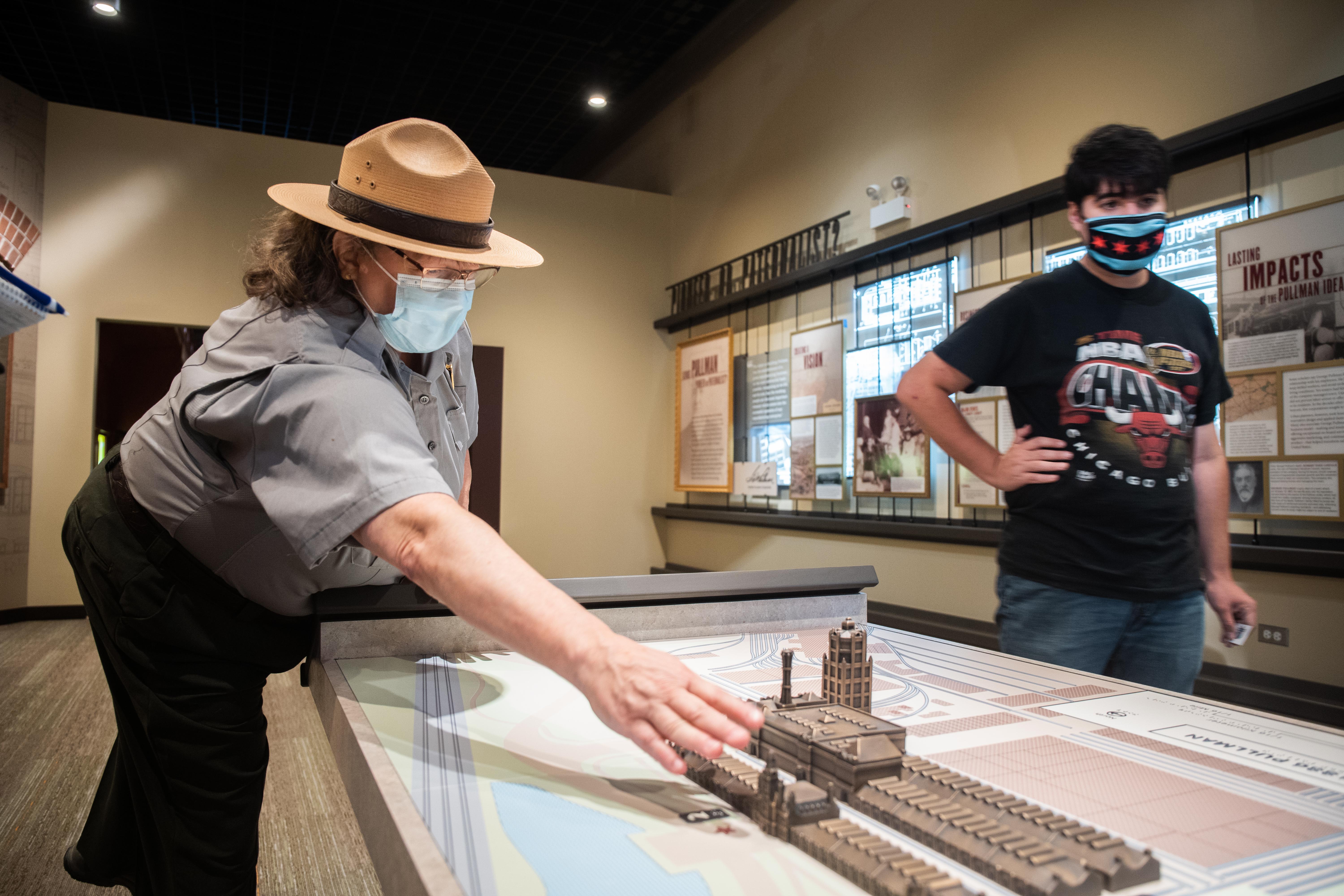 Assistant Superintendent at the Pullman National Monument Sue Bennett points to a replica of the Pullman Palace Car Company factory that is on display at the Pullman National Monument’s visitor’s center on its opening day in the Pullman neighborhood, Saturday afternoon, Sept. 4, 2021.