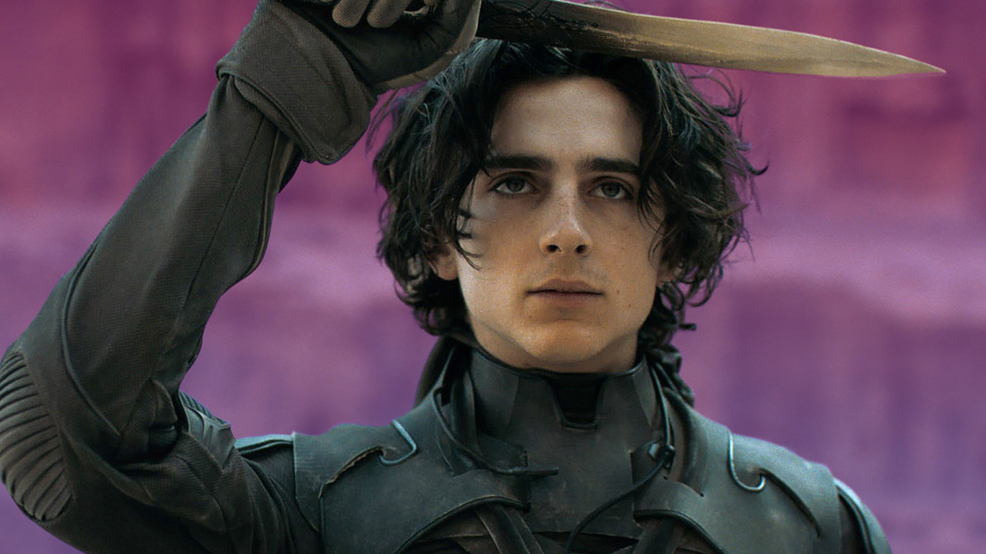 Timothée Chalamet as Paul Atreides in the movie Dune holds a knife to his forehead