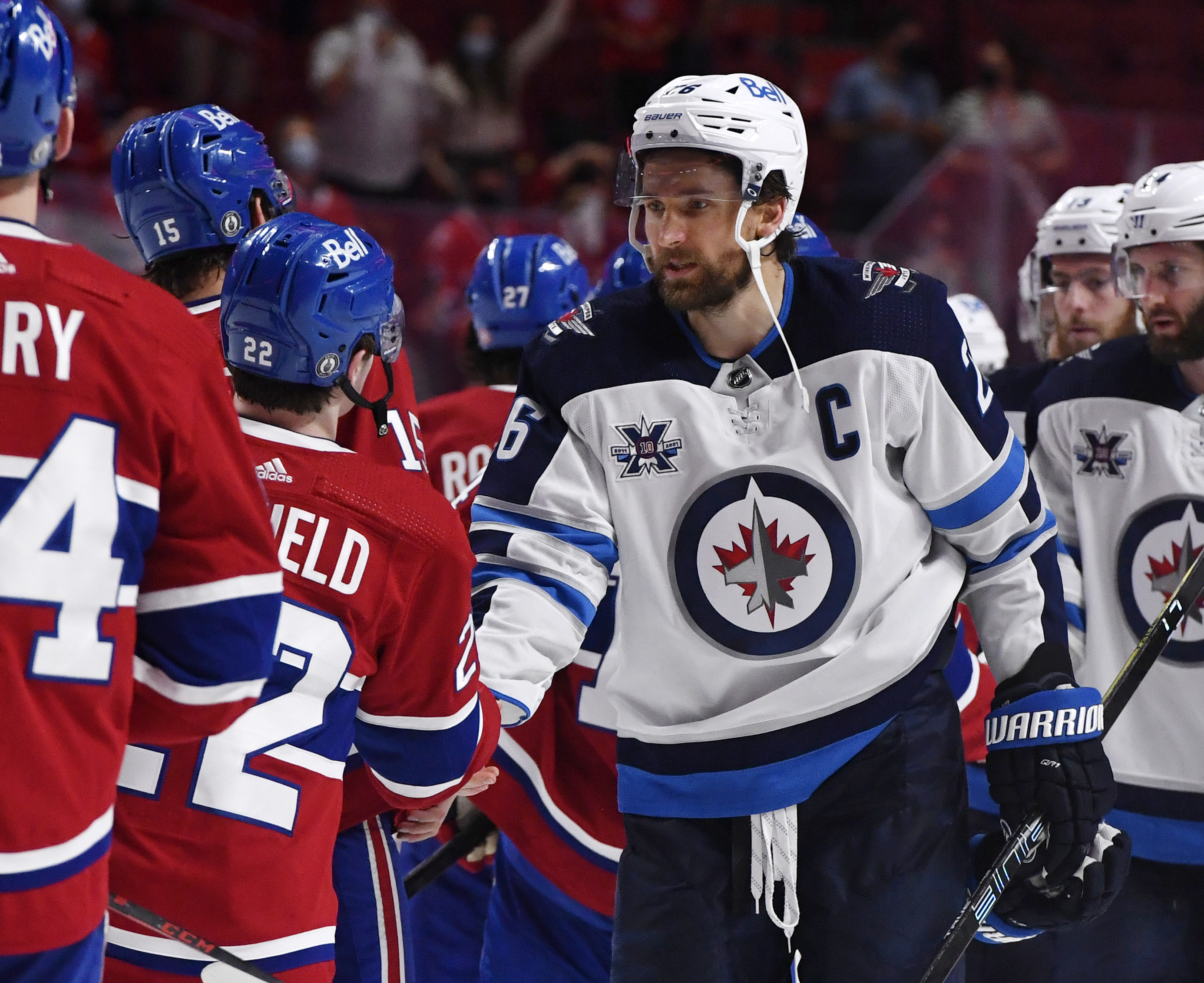 Jun 7, 2021; Montreal, Quebec, CAN; Montreal Canadiens forward Cole Caufield (22) and Winnipeg Jets forward Blake Wheeler (26) shake hands after game four of the second round of the 2021 Stanley Cup Playoffs at the Bell Centre. The Montreal Canadiens swept the series.