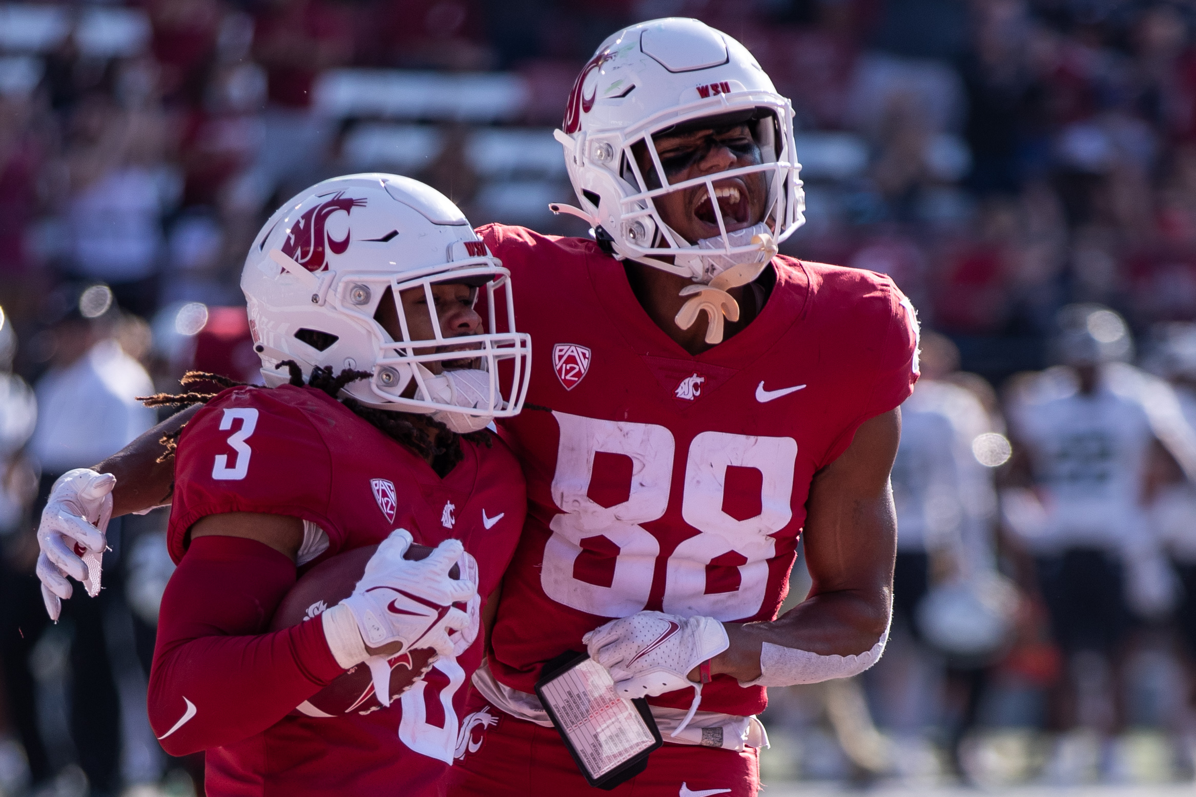 PULLMAN, WA - SEPTEMBER 11: Washington State wide receiver De’Zhaun Stribling (88) celebrates with running back Deon McIntosh (3) after a touchdown run in the first half of a non-conference matchup between the Portland State Vikings and the Washington State Cougars on September 11, 2021, at Martin Stadium in Pullman, WA.