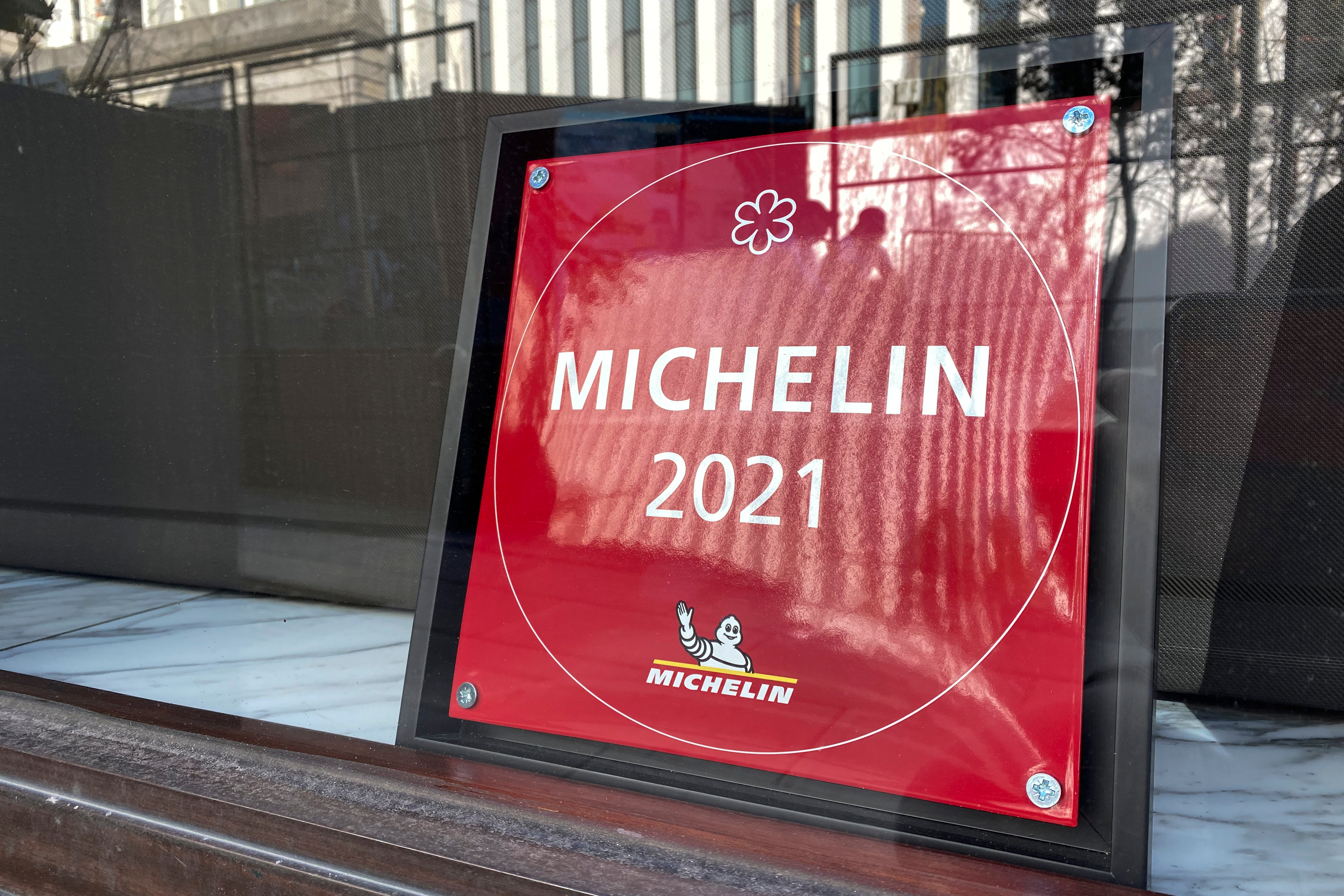 A Michelin 2021 sign sits behind a shop window