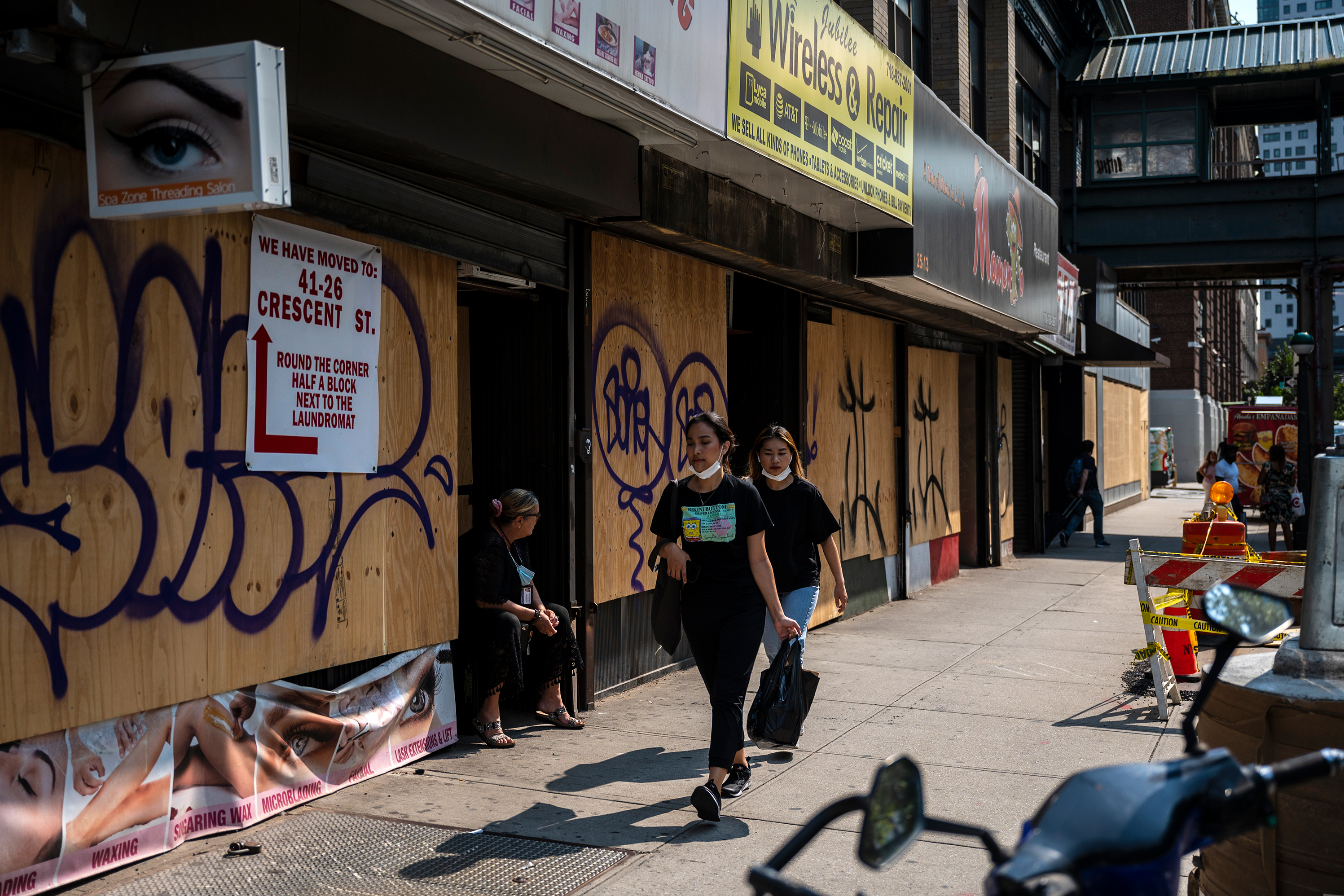 Boarded up storefronts line a block near Queens Plaza, Sept. 14, 2021.