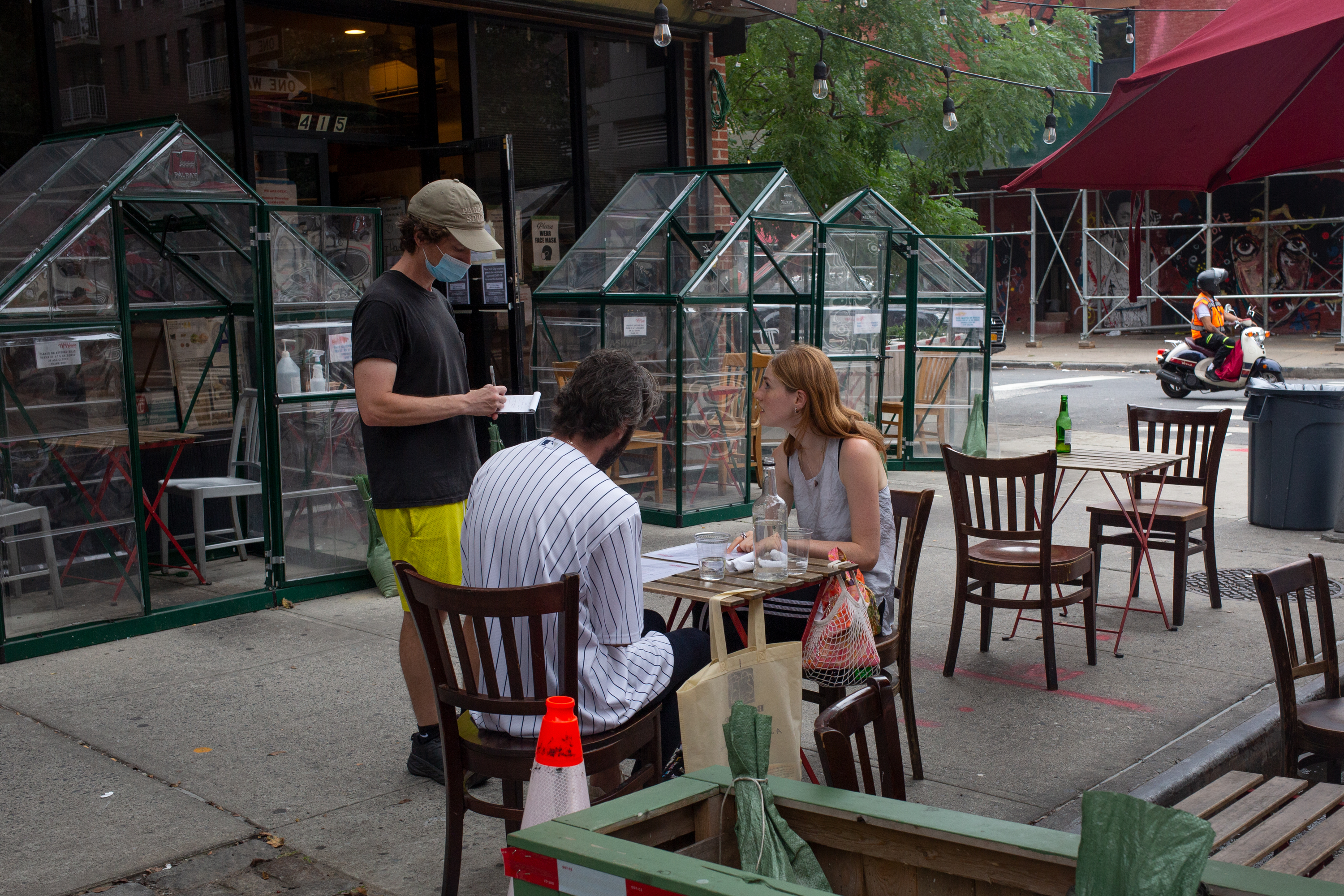 A waiter takes a couple’s order at Peaches HotHouse in Bed-Stuy, Brooklyn, Sept. 16, 2021.