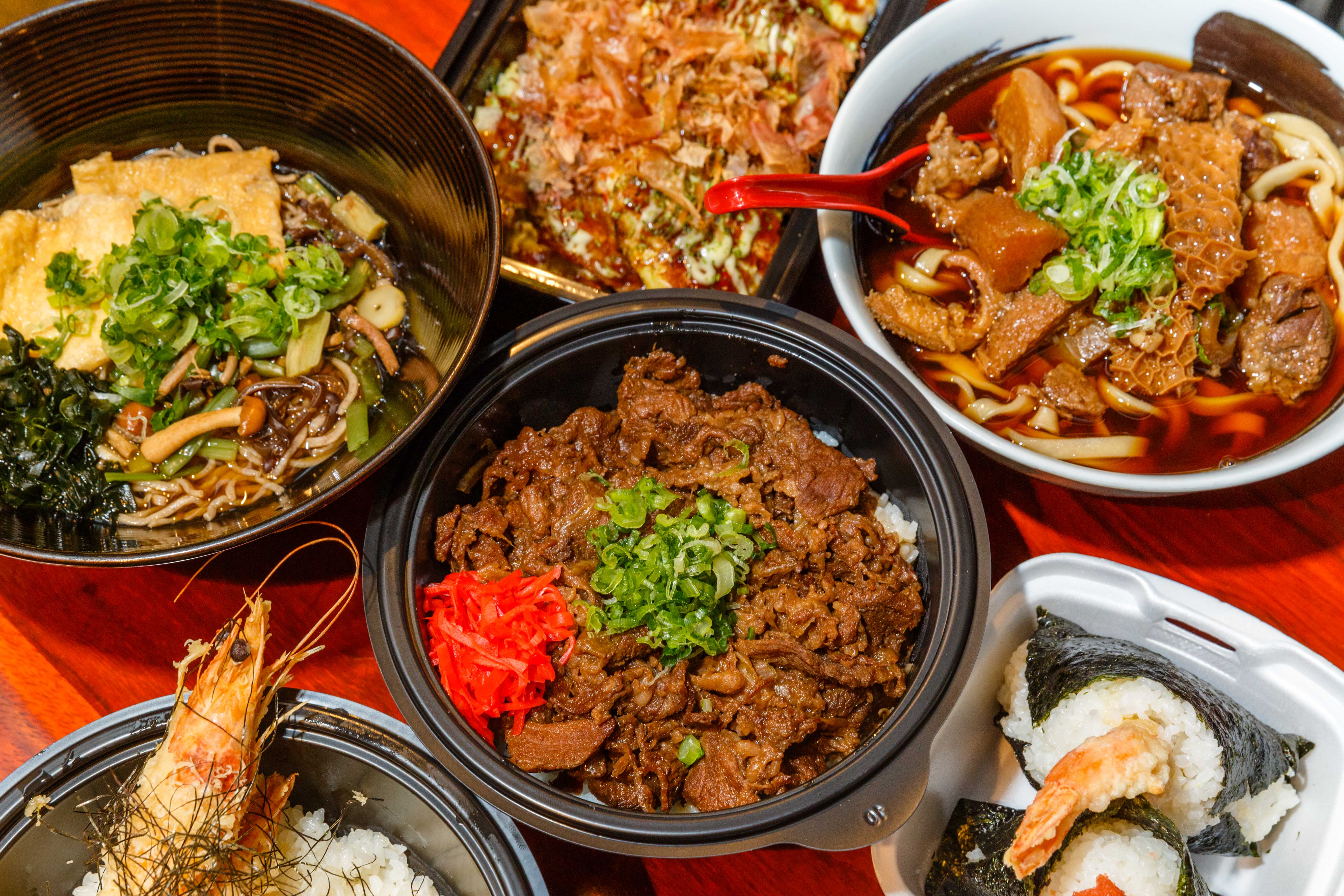 Four bowls of Japanese food seen from above.