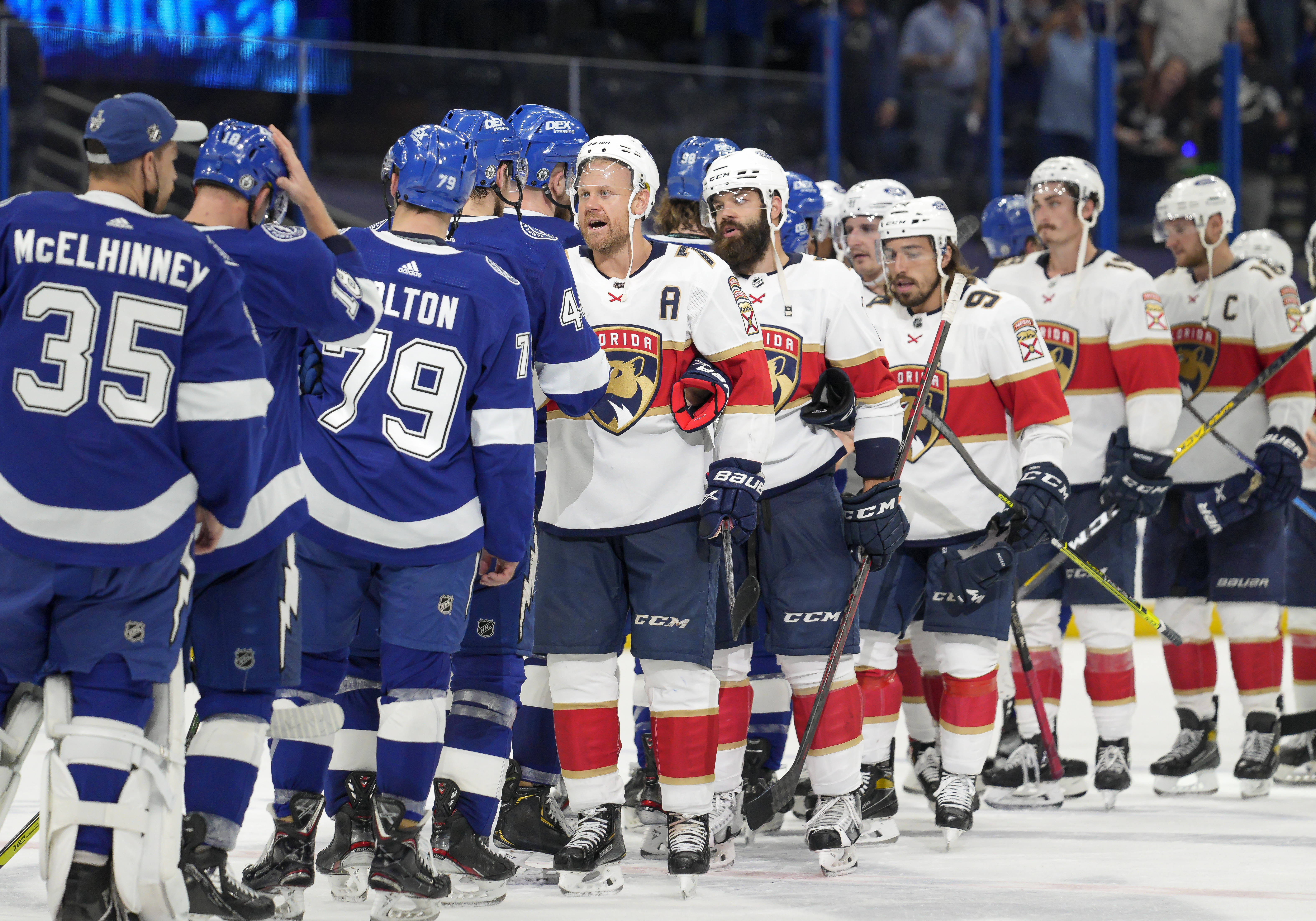Tampa Bay Lightning and Florida Panthers shake hands at the end of the series during the NHL Stanley Cup playoff match Game 6 on May 26, 2021 at Amalie Arena in Tampa, FL.