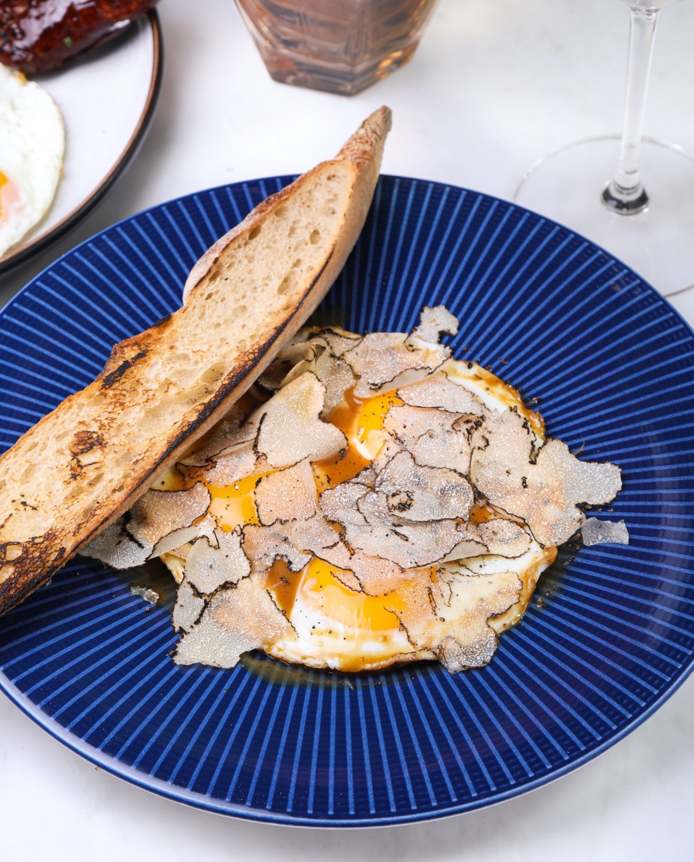 A blue plate with eggs and a side of bread