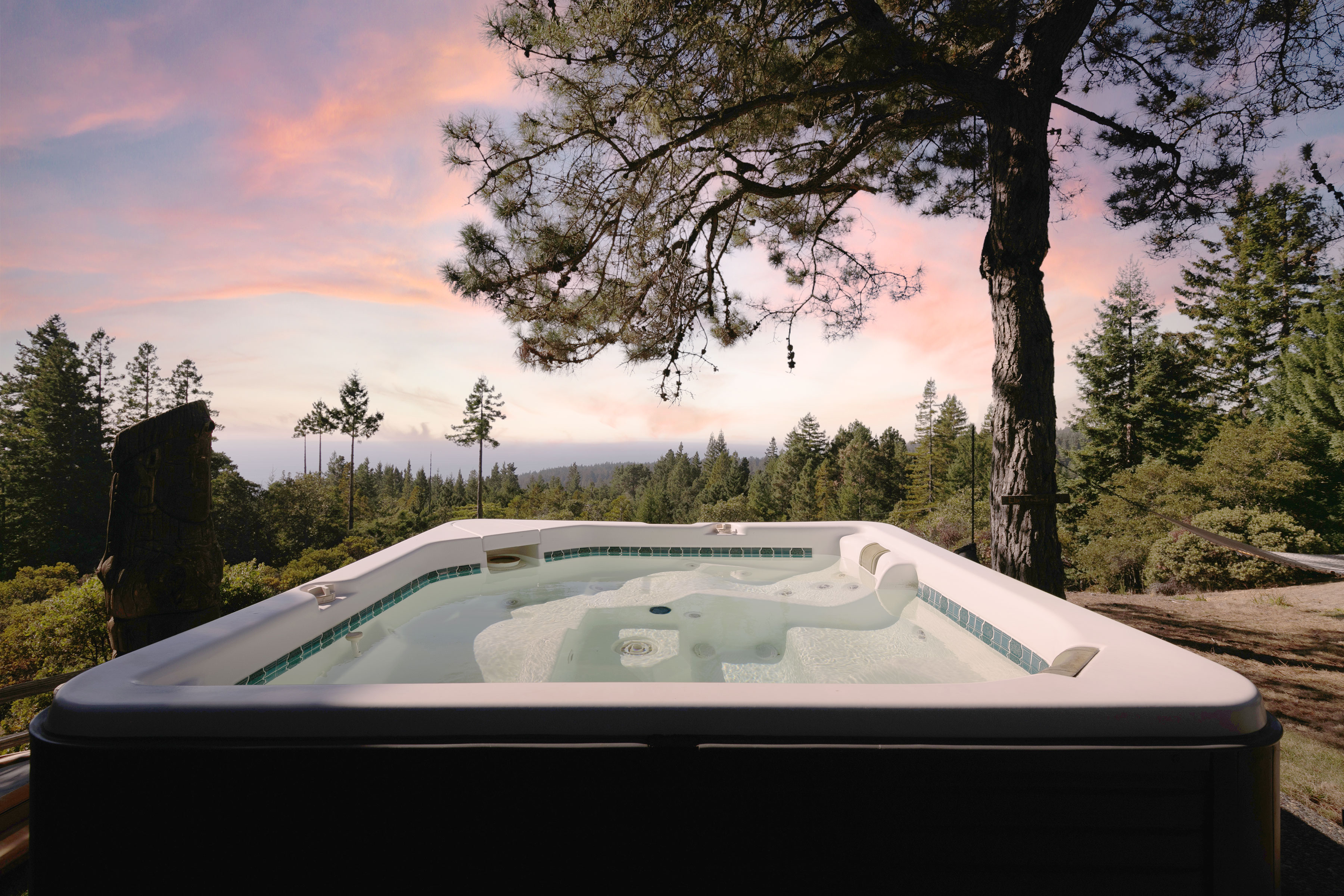 A hot tub overlooking a mountain sunset.