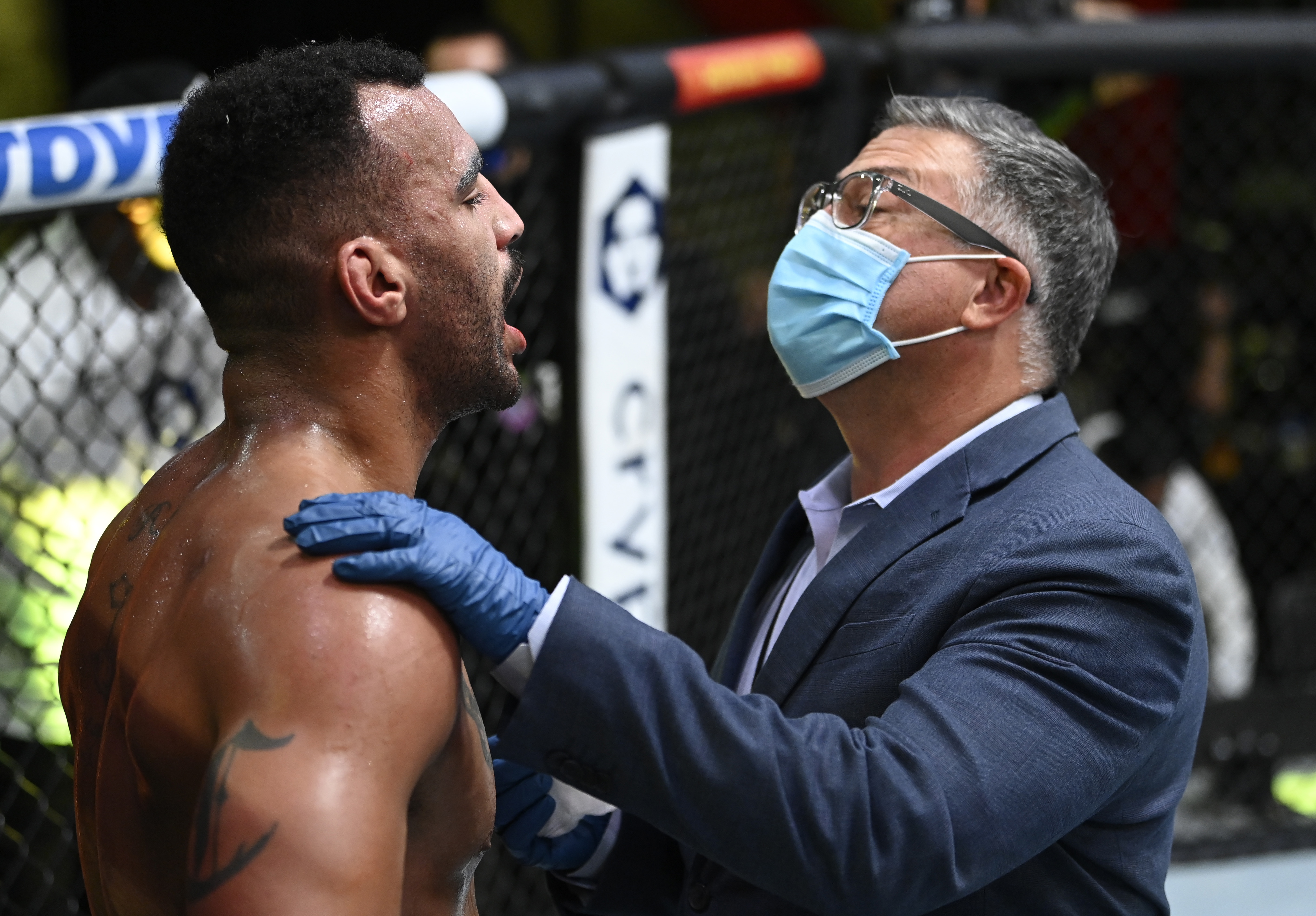 Devin Clark having his teeth examined by the cageside physician in between rounds at UFC Vegas 37. 