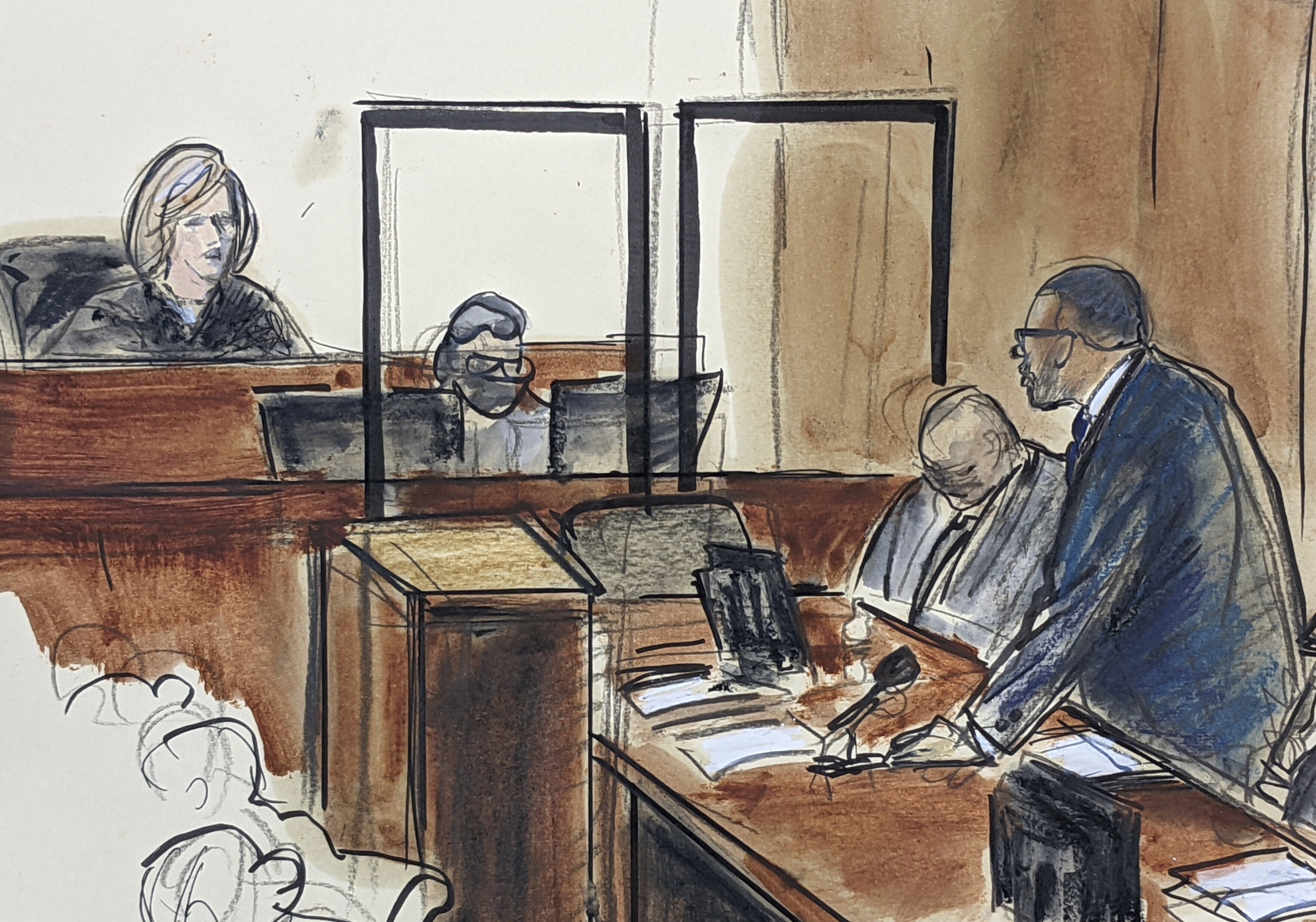 In this illustration drawn from a video feed, R. Kelly, right, stands and responds to Judge Ann Donnelly’s question whether or not he has decided to take the stand in his own defense, Wednesday, Sept. 22, 2021, in New York. 