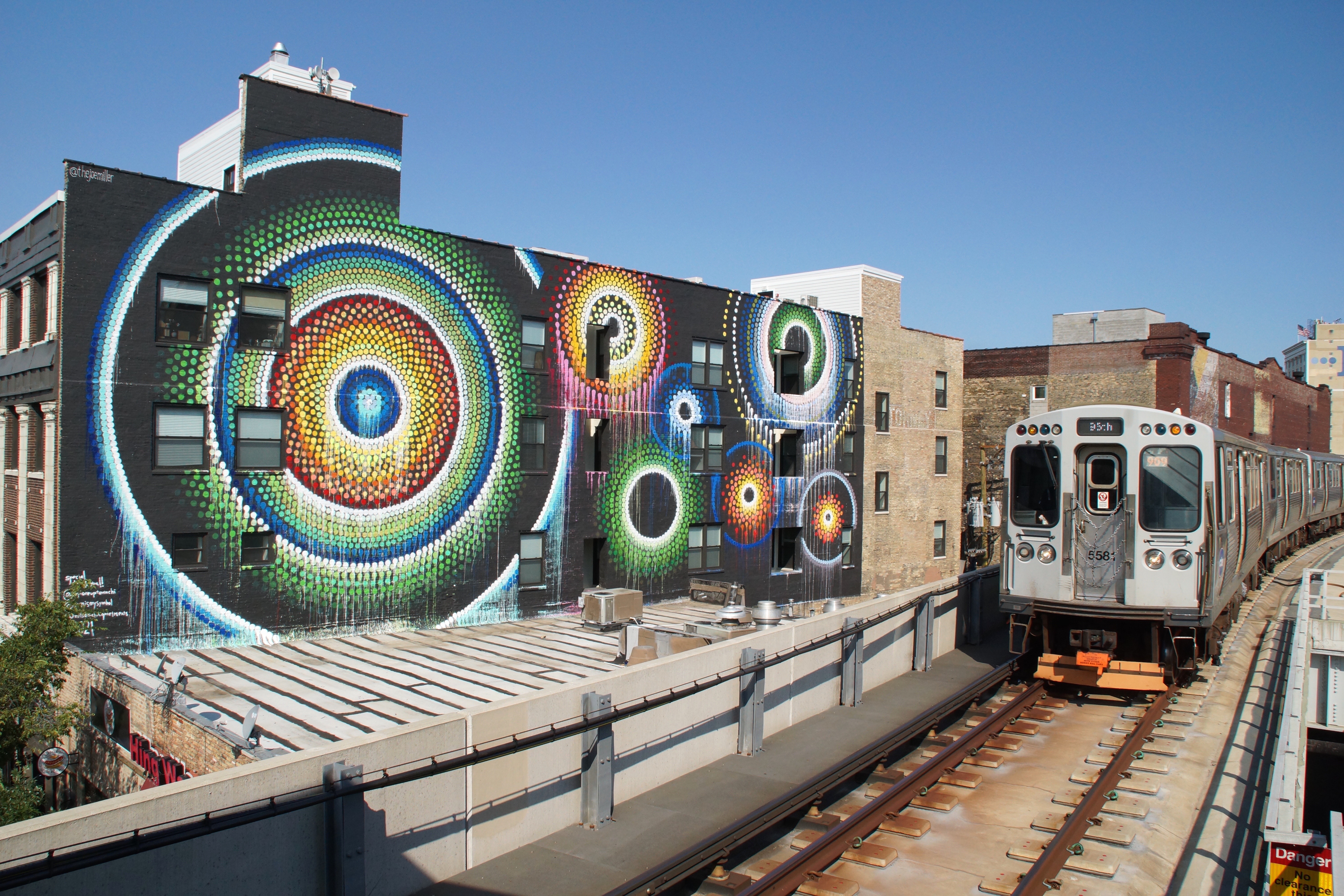 A southbound Red Line L train passes Joe Miller’s “Uptown Dot King” mural at 1124 W. Wilson St. in Uptown. The Lincoln Square artist always wanted to do a large-scale mural that could be seen from a train platform.