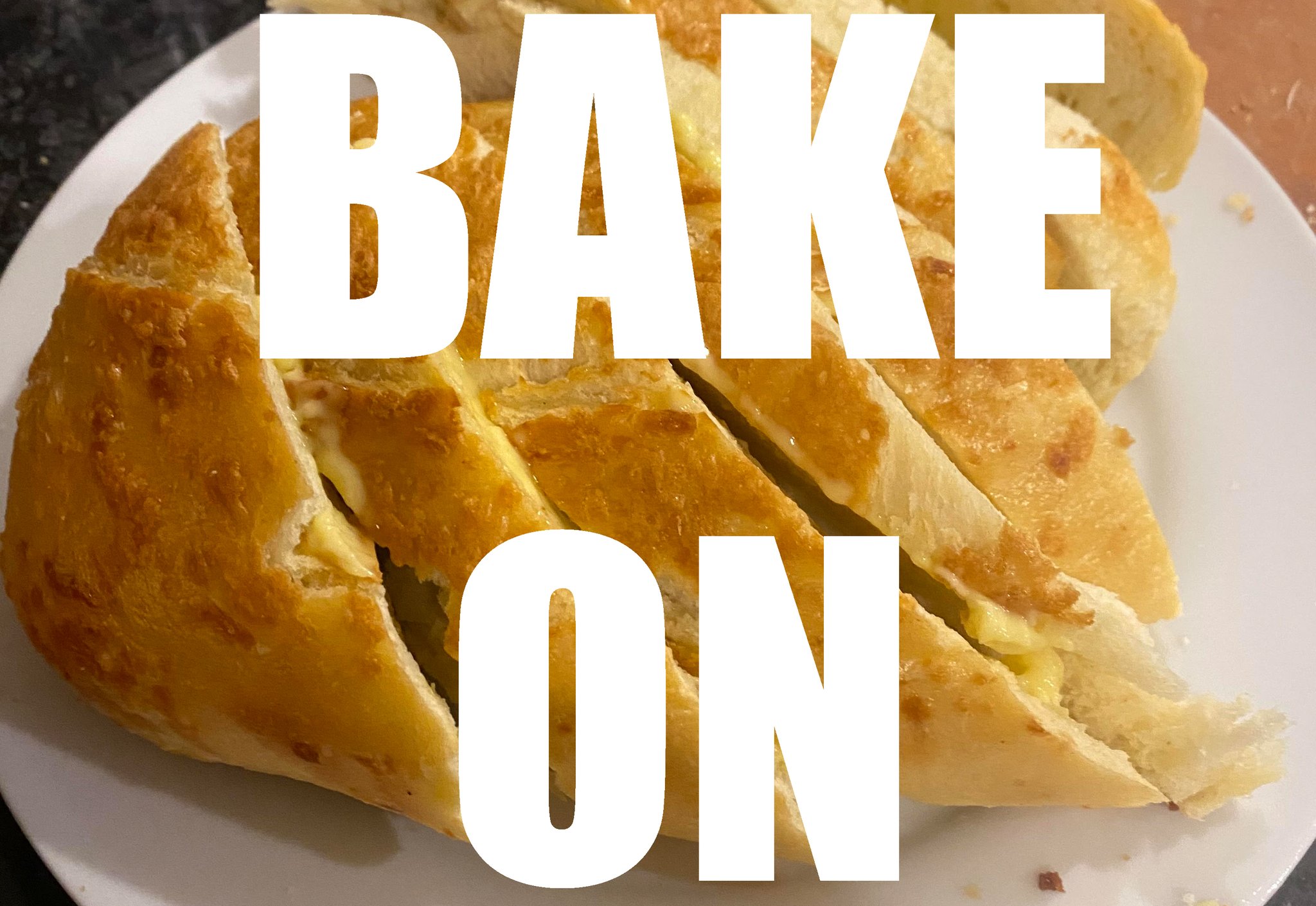 White all-caps text reads” BAKE ON”, superimposed over a photo of sliced bread.