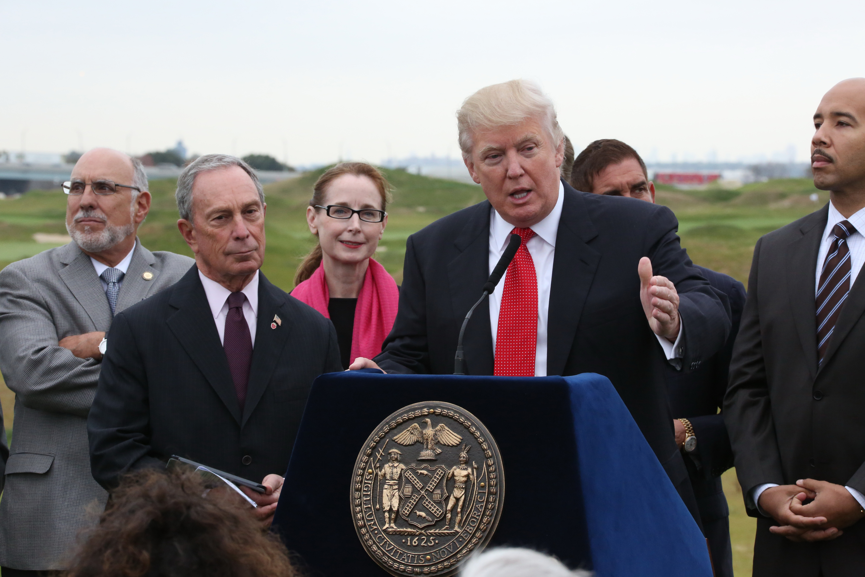 Donald Trump speaks alongside former Mayor Michael Bloomberg at the opening of the Trump Golf Links in The Bronx, Oct. 16, 2013.
