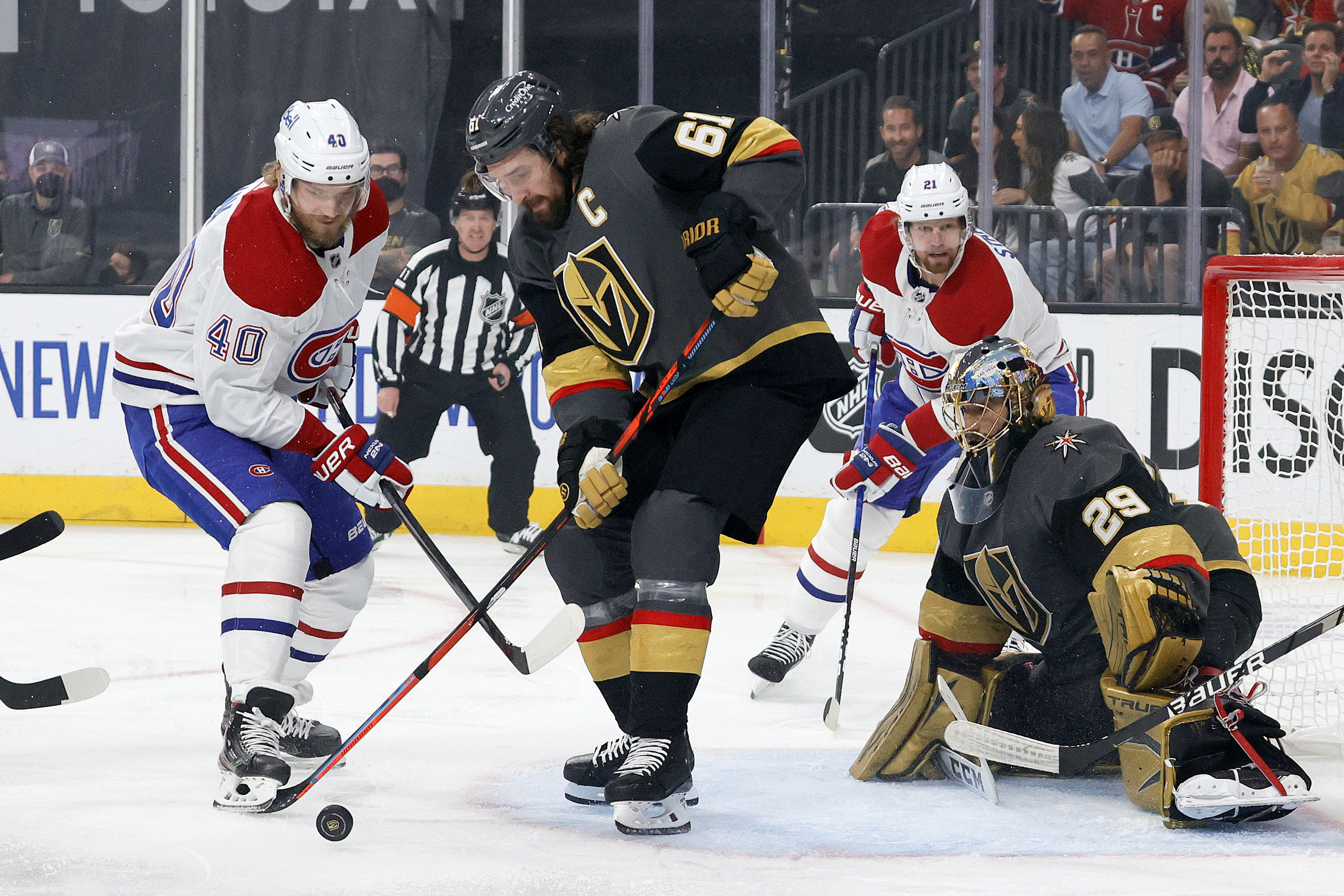 Joel Armia #40 of the Montreal Canadiens and Mark Stone #61 of the Vegas Golden Knights battle for the puck as Marc-Andre Fleury #29 tends net during the first period in Game 5 of the 2021 Stanley Cup Playoffs at T-Mobile Arena on June 22, 2021 in Las Vegas, Nevada.