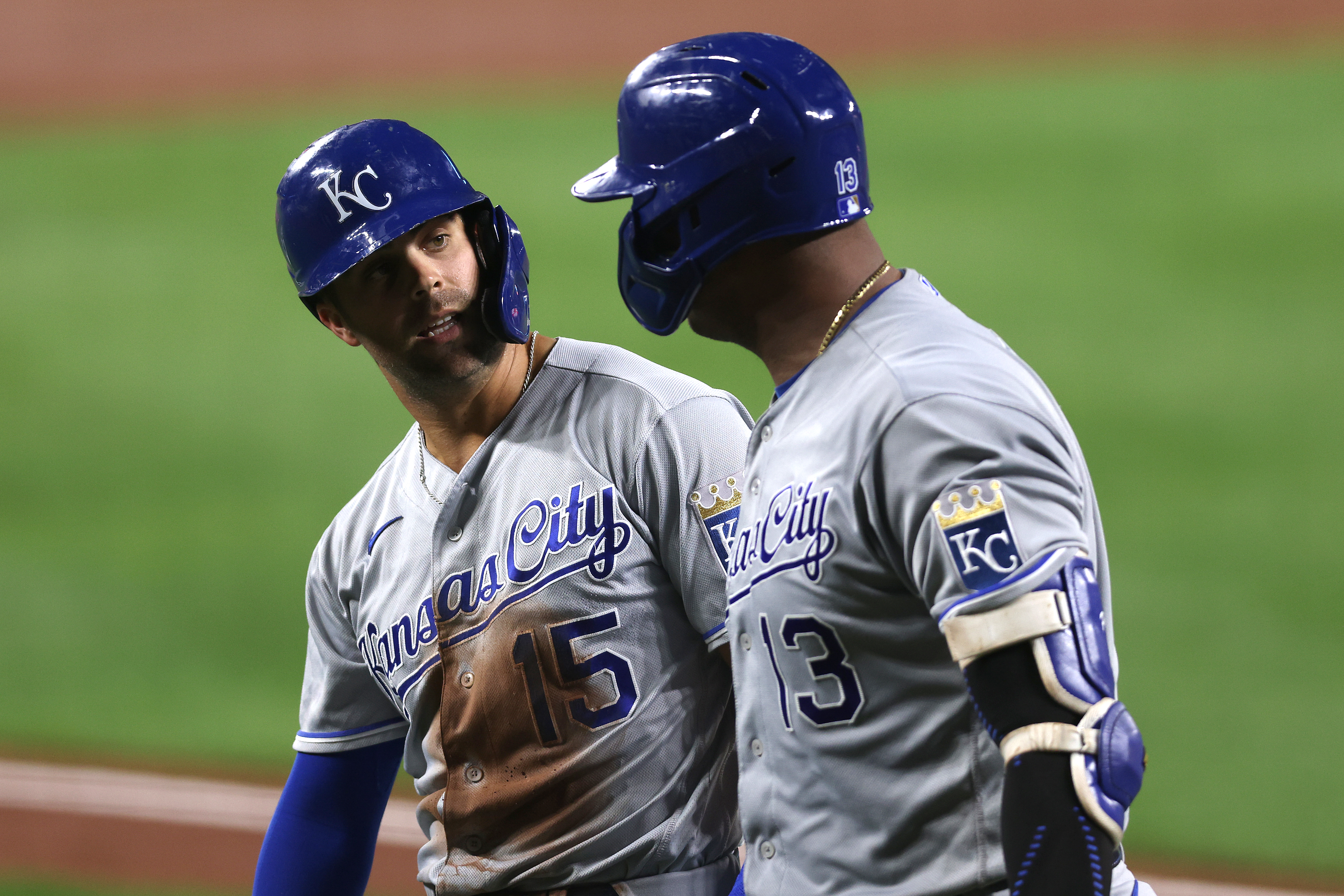 Whit Merrifield #15 talks with Salvador Perez #13 of the Kansas City Royals after scoring a run in the third inning against the Baltimore Orioles at Oriole Park at Camden Yards on September 08, 2021 in Baltimore, Maryland.