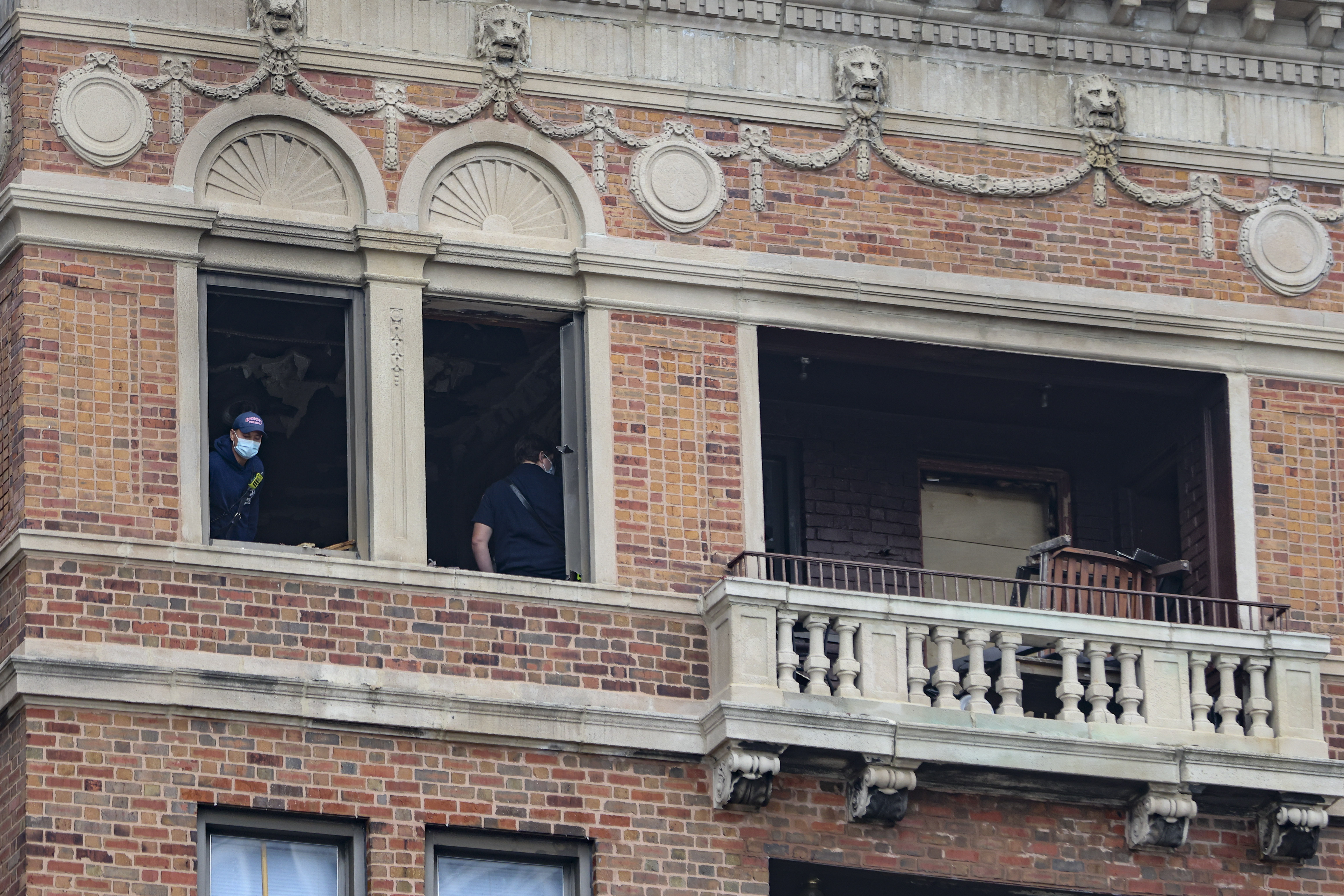 Fire department personnel inside the apartment Tuesday, Oct. 5, 2021, near the 400 block of West Wrightwood Avenue in Lincoln Park where a fire took place on the 7th floor and a man fatally jumped out of the window to escape.
