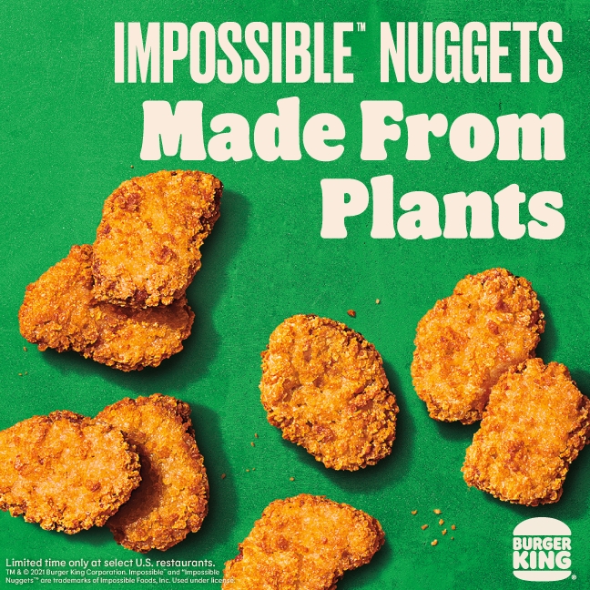 A promotional poster from Burger King advertises the company’s new Impossible nuggets, with the slogan “Made From Plants” printed in white font against a green background.
