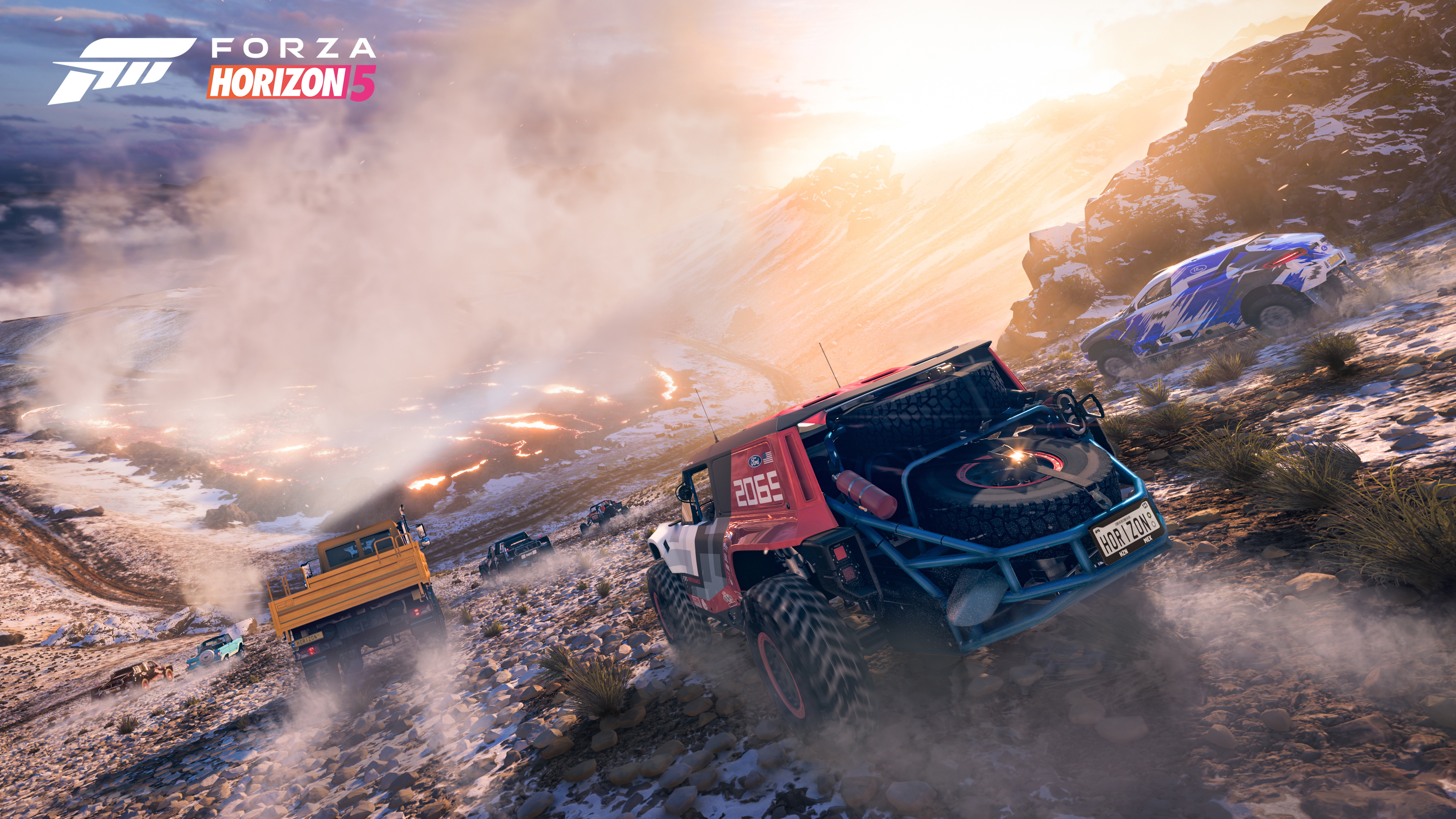 cars race down the side of a volcano, with patches of snow and steam rising in the distance, in Forza Horizon 5