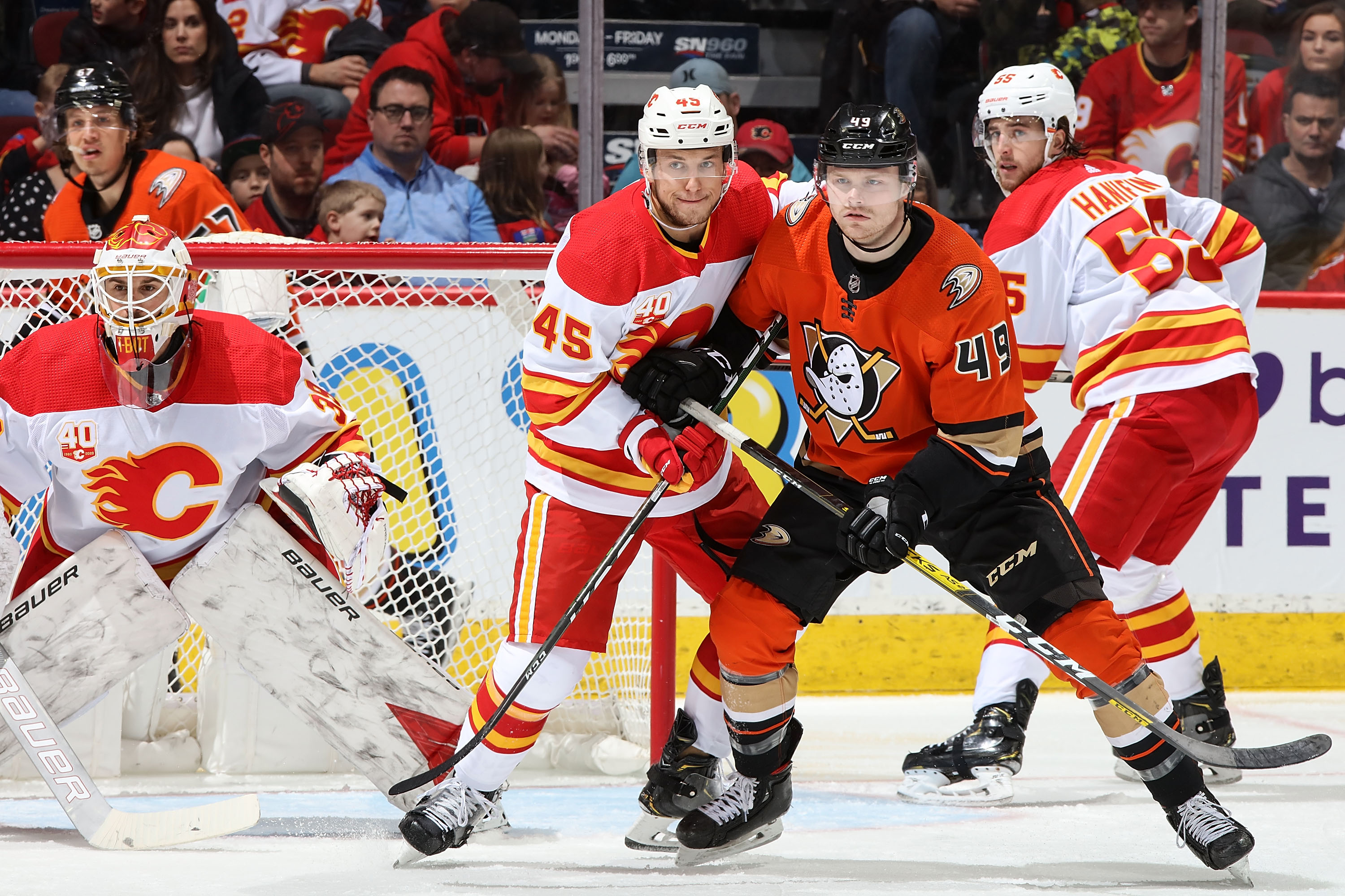 Alexander Yelesin #45 of the Calgary Flames and Max Jones #49 of the Anaheim Ducks compete for position during an NHL game on February 17, 2020 at the Scotiabank Saddledome in Calgary, Alberta, Canada.