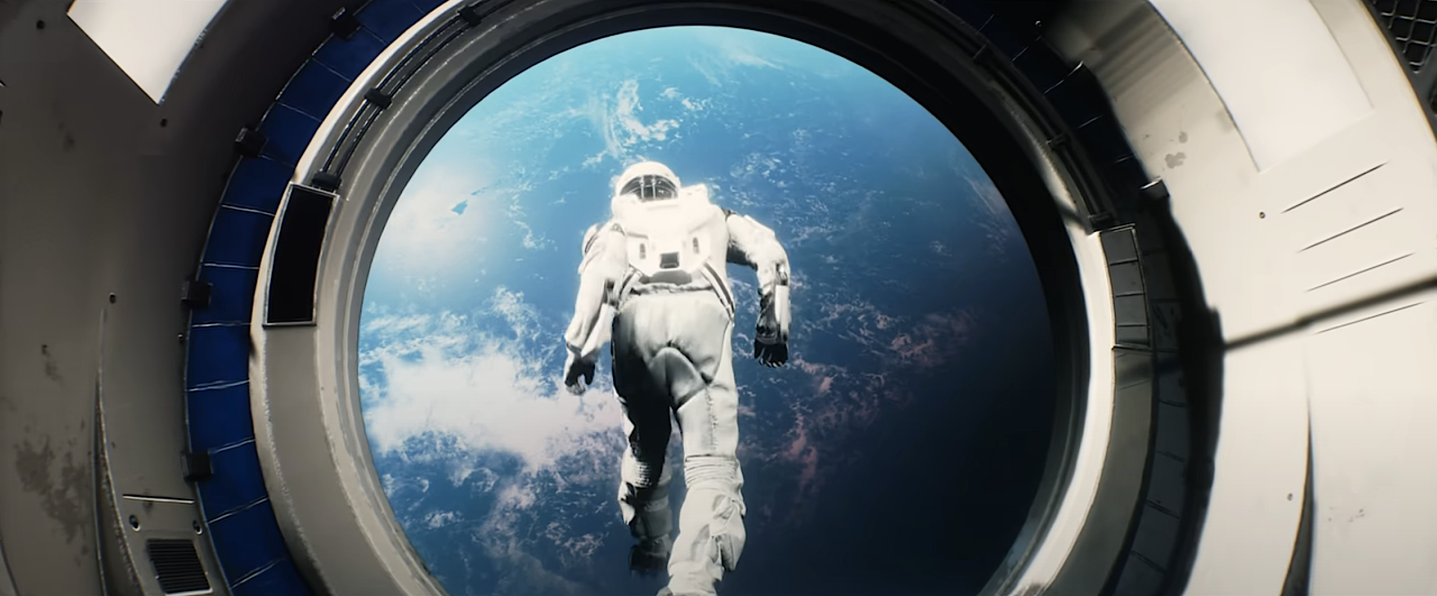 A man in a spacesuit, silhouetted against Earth, leaps through of a portal into space in Warning