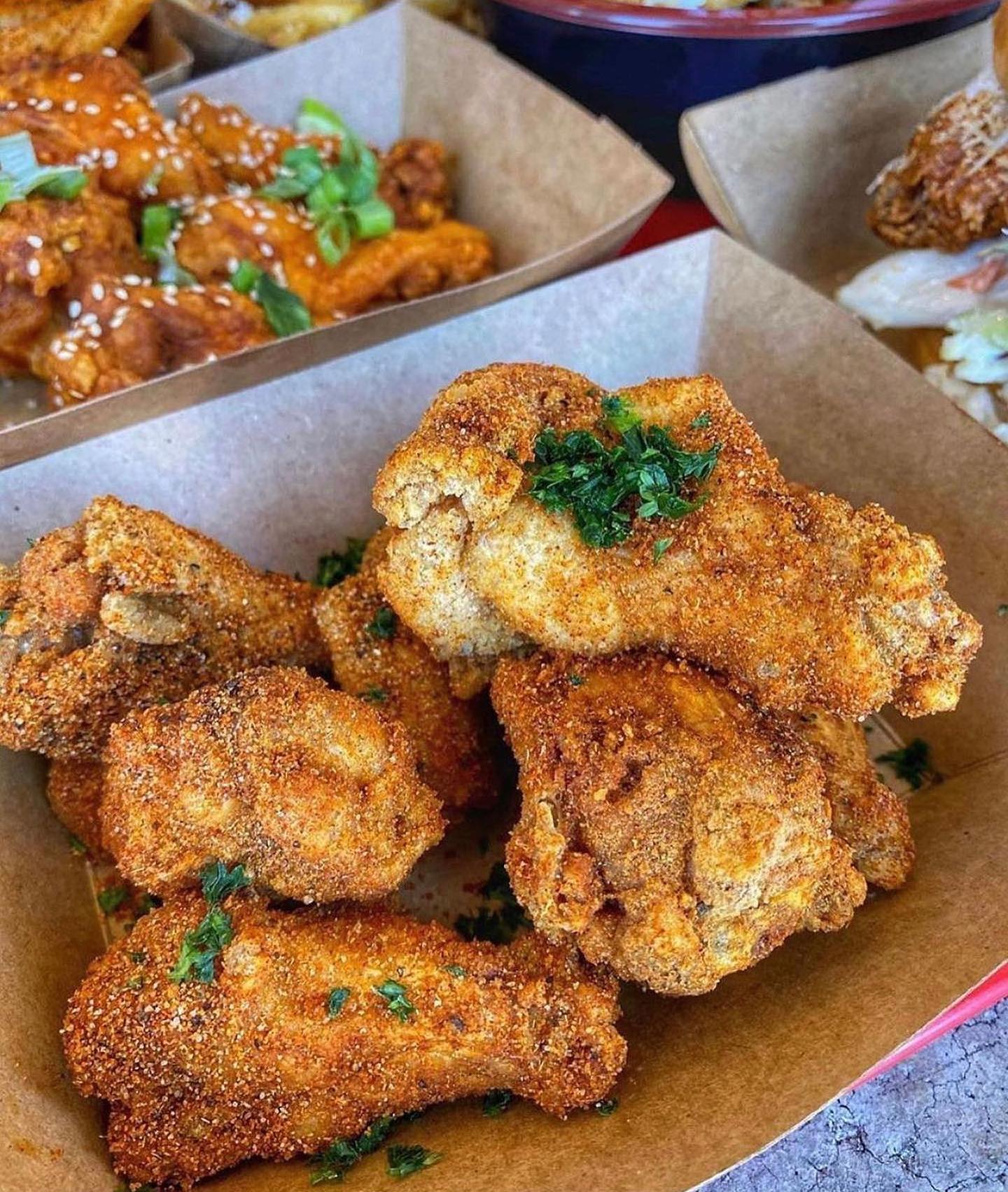 fried chicken wings in brown cardboard container